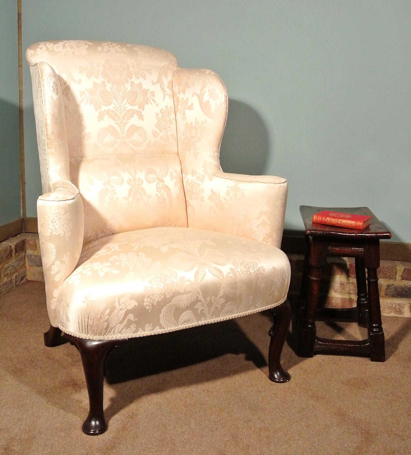 On behalf of a local estate.

A very handsome George III walnut wing back chair circa 1780, newly and professionally upholstered in a top quality Gainsborough Silk Weaving Company fabric of a pale cream color.

A Victorian button is fitted to the