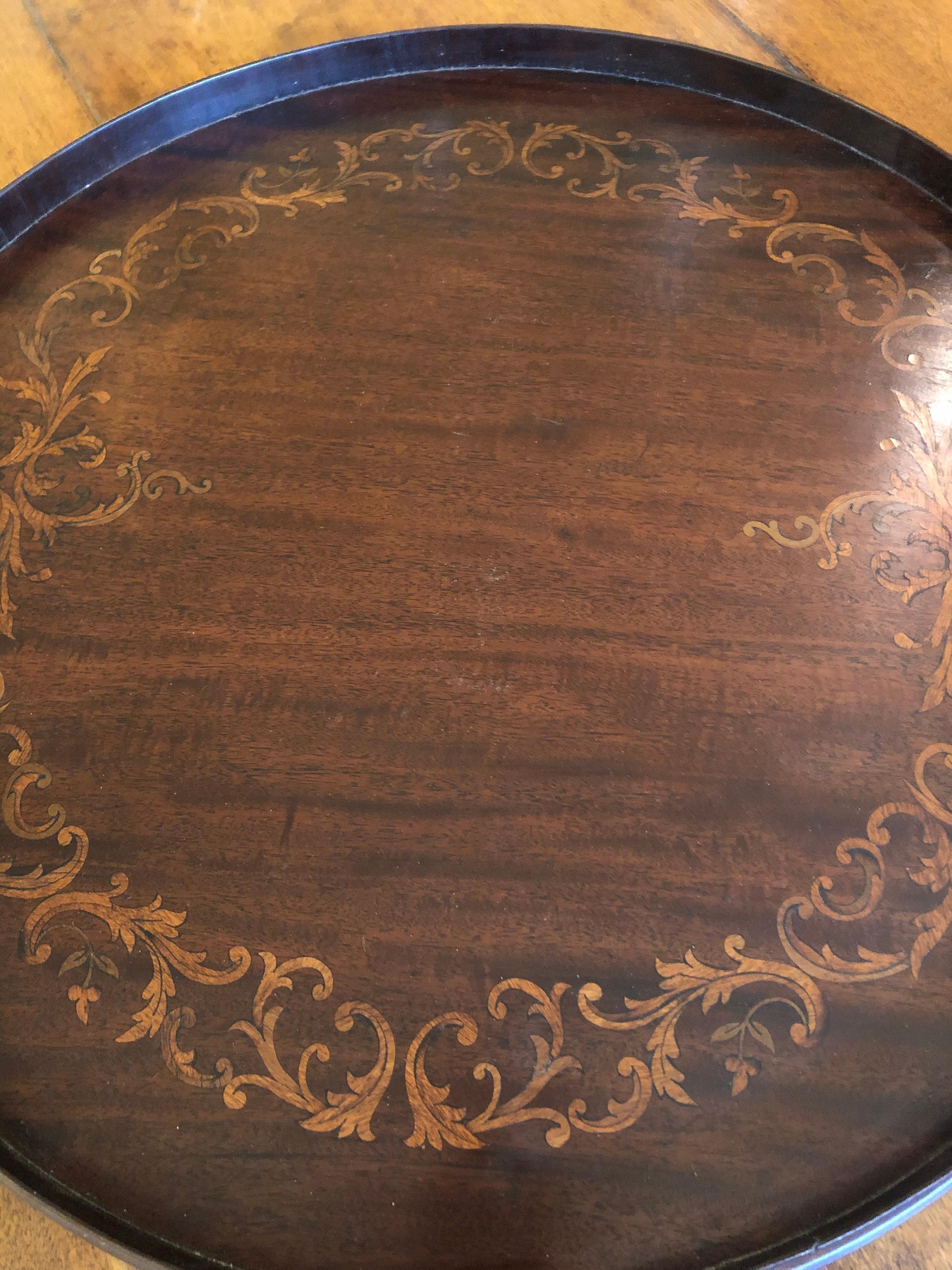 A beautiful vintage round wooden serving tray having inlay design and brass handles.
Diameter of tray itself 19.5
Tray height without handles 1.75.