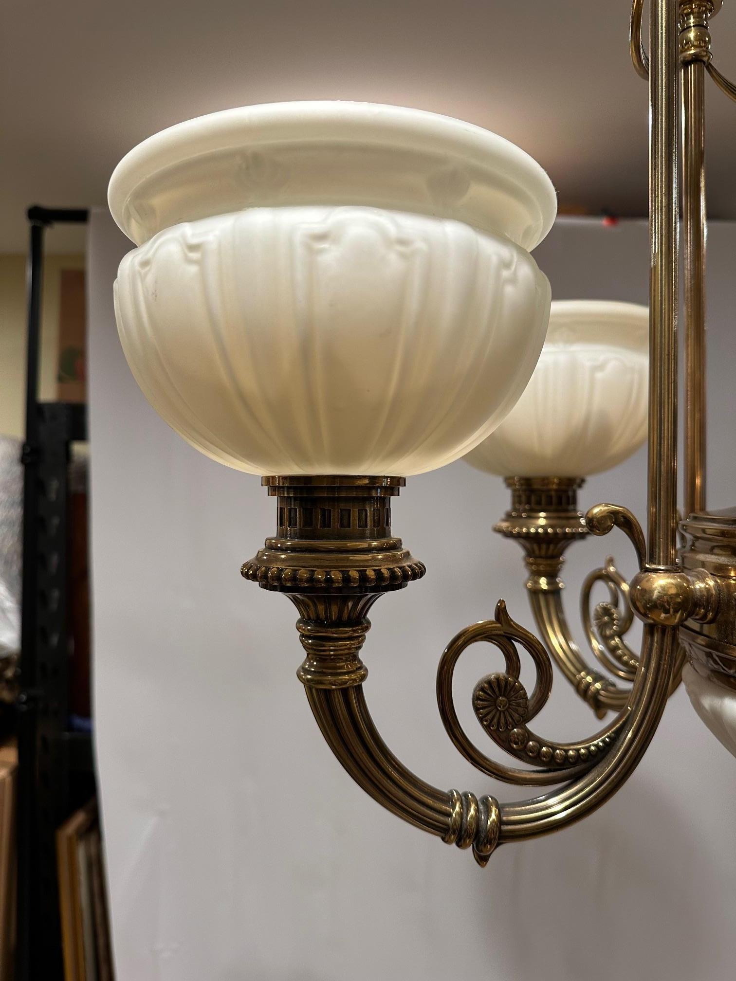 Handsome brass chandelier by Kitchler lighting having 5 arm globes;
Center globe has bulb as well.
Victorian style