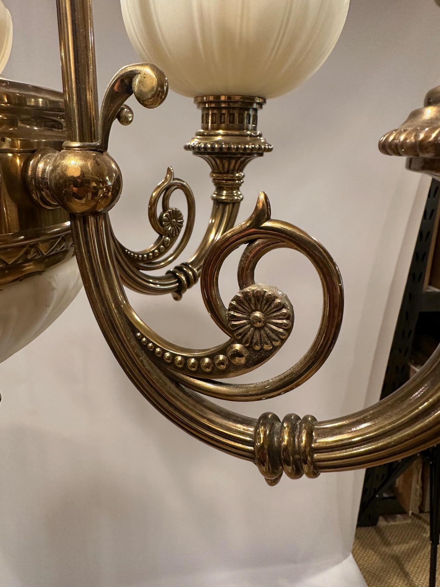 Contemporary Handsome Kitchler Brass and White Opaque Glass Chandelier with 5 White Globes