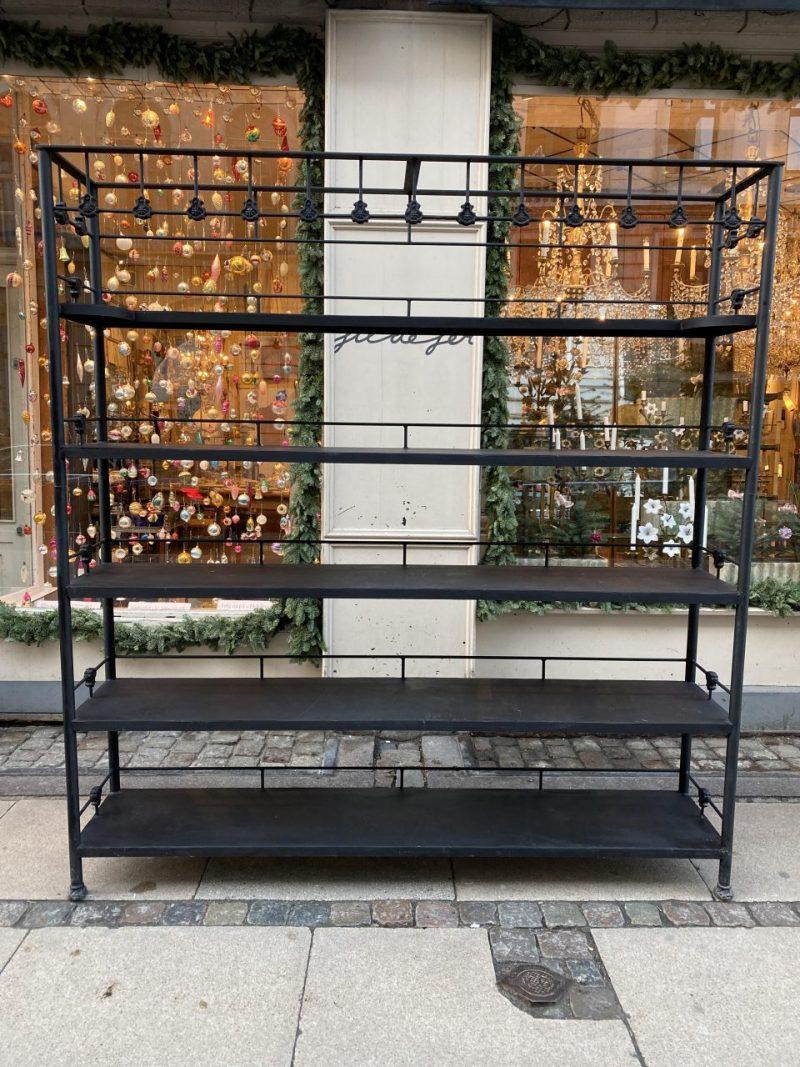 Large and handsome iron shelving unit, ingeniously made out of two early 20th century French iron beds. The shelving is constructed with slim iron rods joined decoratively at an angle.

The whole unit is painted black, and houses 5 spacious shelves,