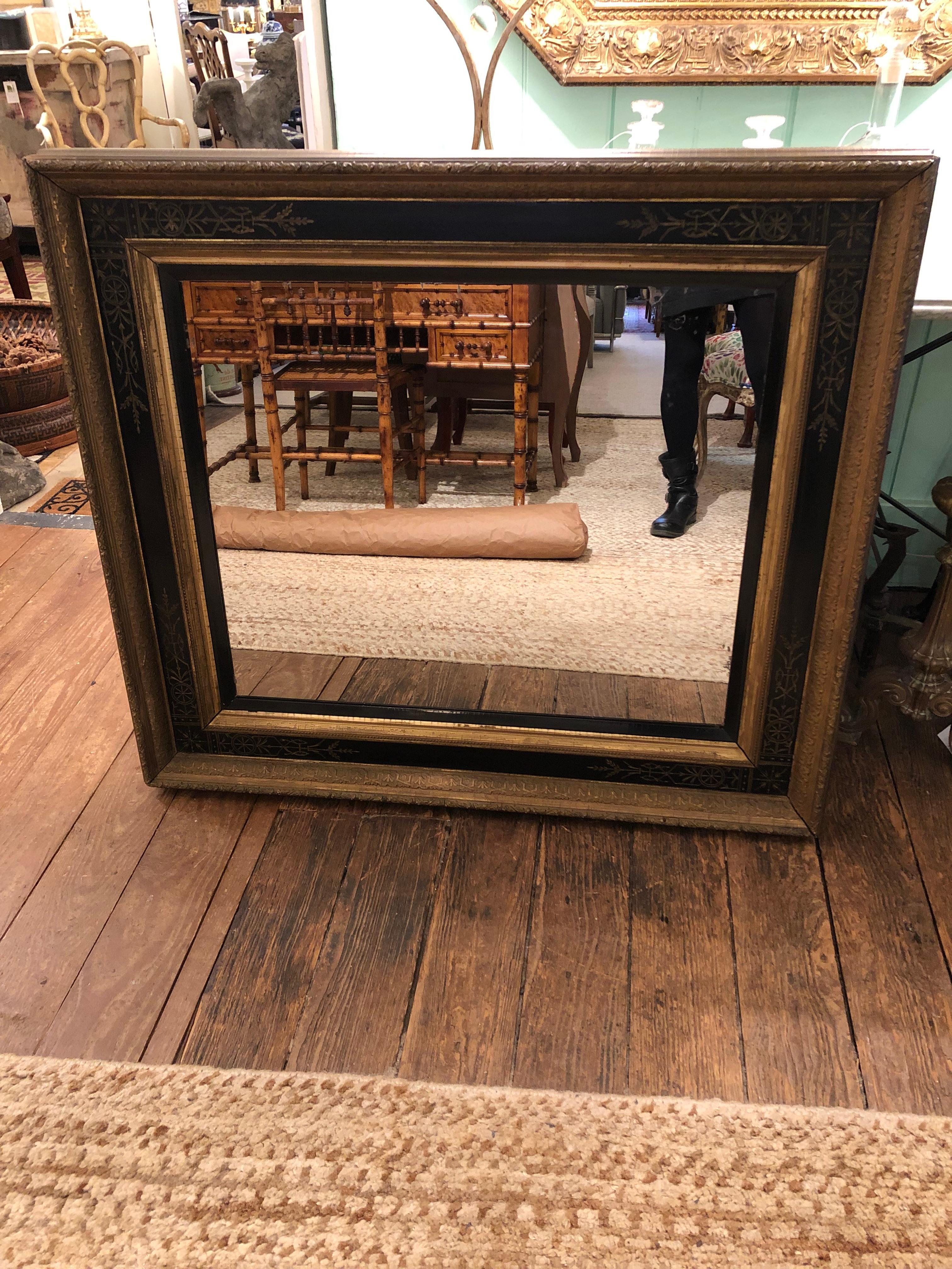 Impressive large Victorian mirror having wide gold and black frame with lovely painted decoration and multiple moldings that give it a dimensional effect. Mirror has some mercury signs of age.
mirror itself measures 29.25 W 24.75 H.