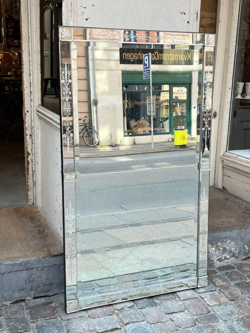 Gorgeous old Venetian mirror from France, around 1920 – 1940, with fantastic patina in the mirrored glass.

From the era, where the faceted ornaments, would elegantly reflect the light.

Beautiful floral ornamentation in the frame along the