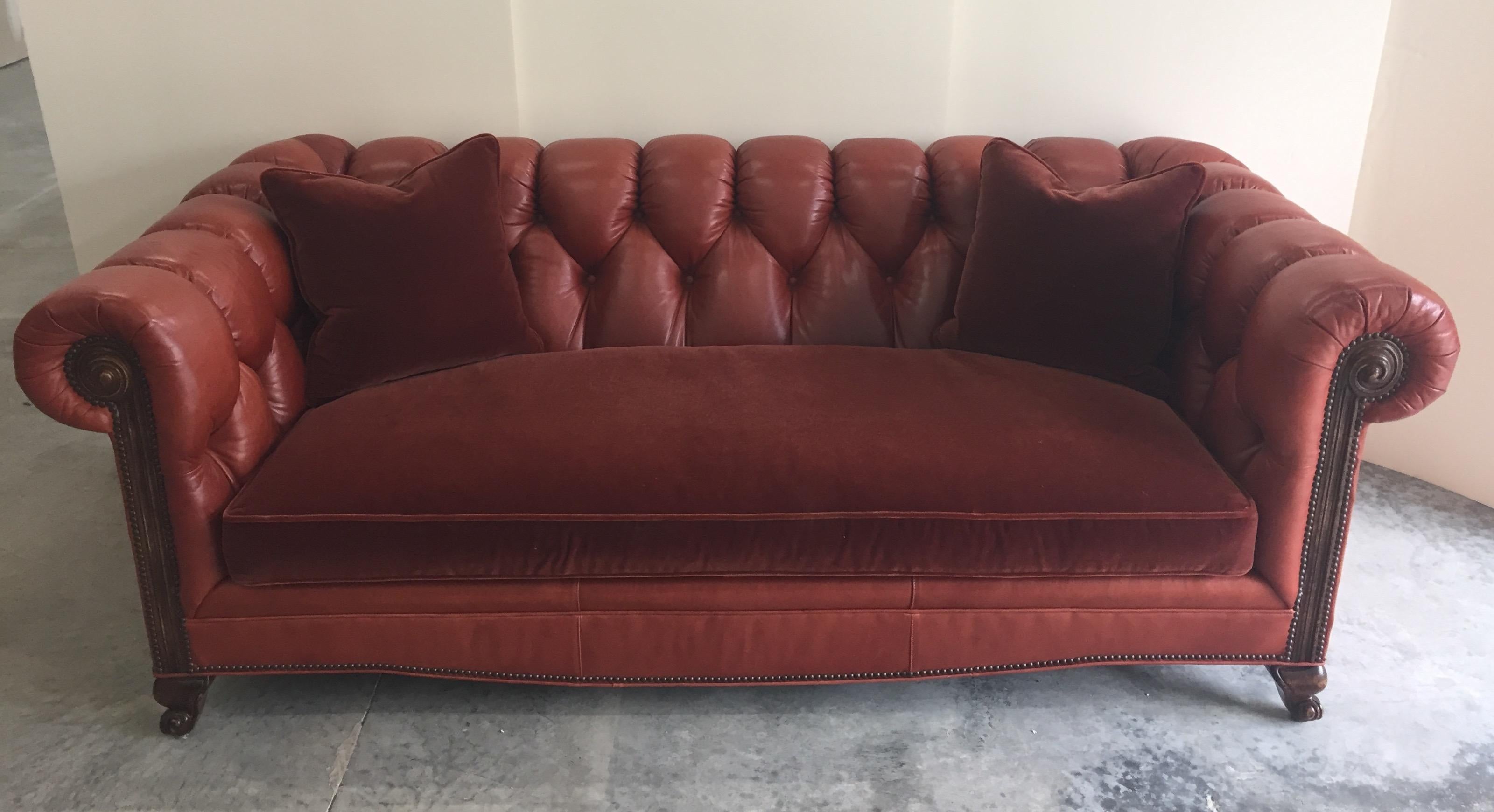 Comfy and classic rusty brownish orange leather tufted Chesterfield sofa having a yummy mohair upholstered seat cushion. Brass nailhead details and mahogany feet.
 seat depth 25.