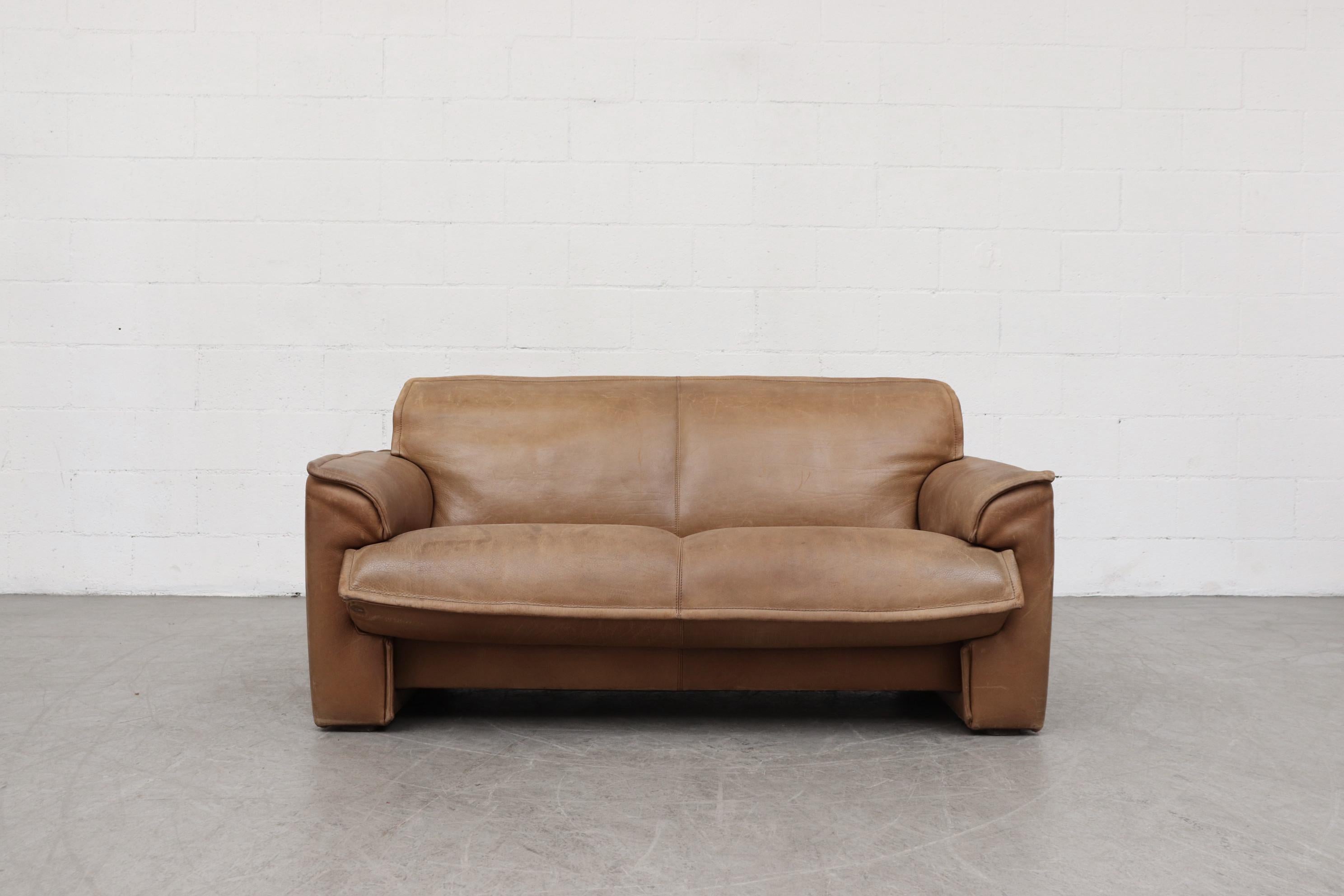 Leolux Buffalo leather love seat sofa in very original condition with heavy patina and visible signs of wear. Other similar sofas available in this color tone a with heavier patina and others in darker leather, listed separately. Actual color may