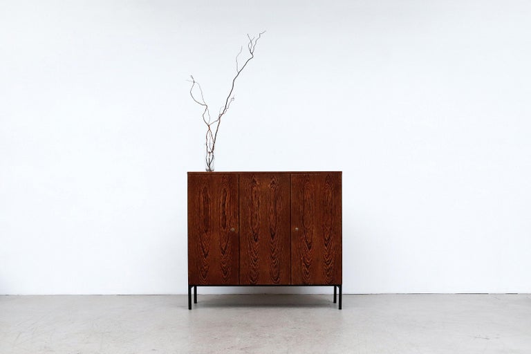 Handsome Tall Martin Visser wenge sideboard. Beautiful sideboard and room divider, as it is finished on the back. Cabinet has 3 doors, white formica shelves and black enameled metal legs. In original condition, wear consistent with its age and use.