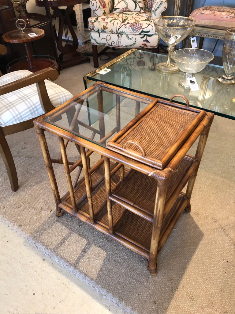 Versatile stylish bamboo and rattan side table having removeable tray on top and half glass surface. There are two lower tier shelves and slats for magazines.
Tray handles ad 2.5 to top.