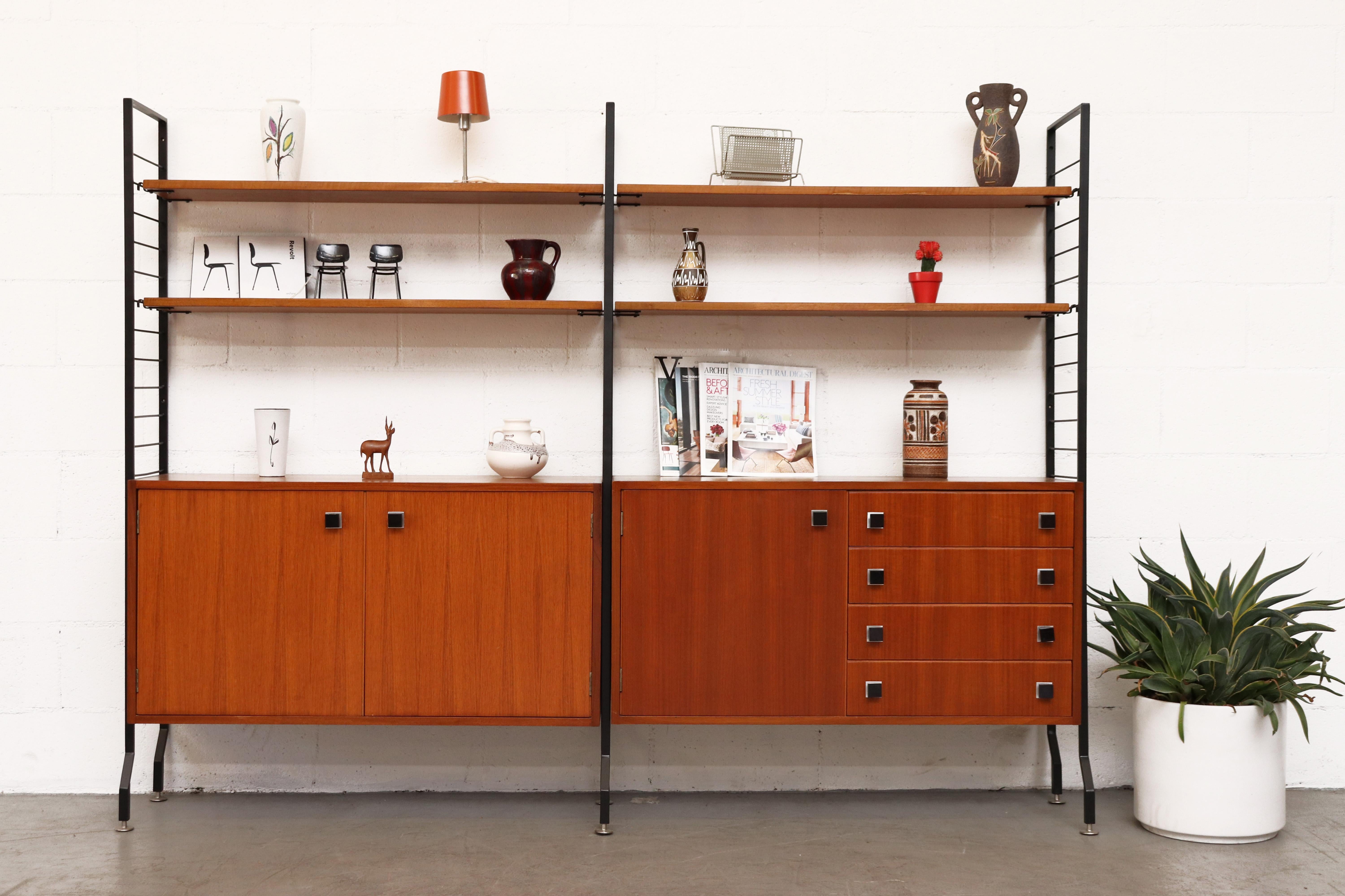 Handsome midcentury teak wall unit. Fantastic storage and shelving. Cabinets in original condition with new made shelving. Frames and cabinets have some signs of wear consistent with age and use.