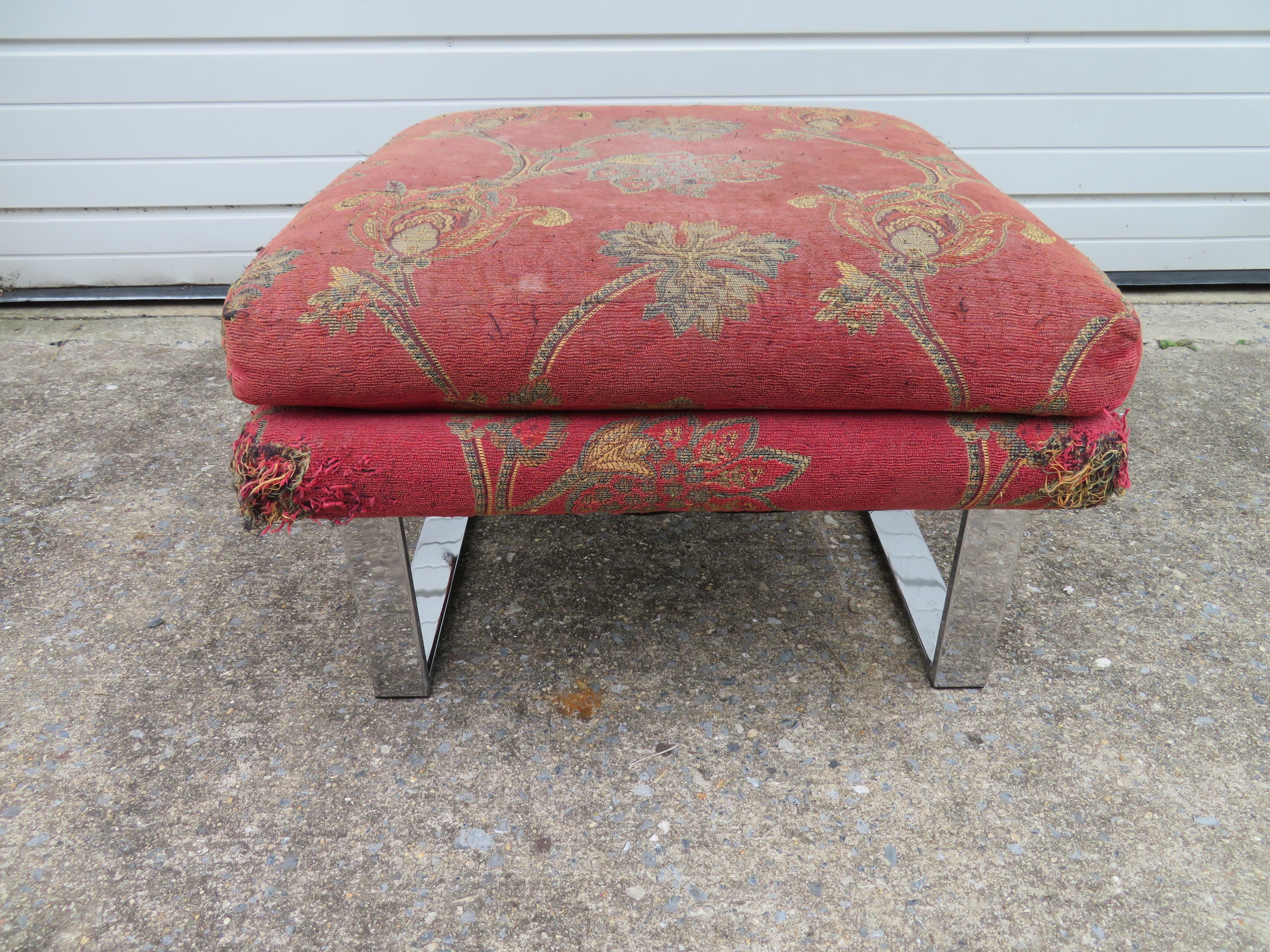 Handsome Milo Baughman chrome ottoman. The upholstery is worn and dated and will need to be re-upholstered. The chrome looks great shows only mild wear, we do like to see a bit of wear with all the reproduction pieces out there.