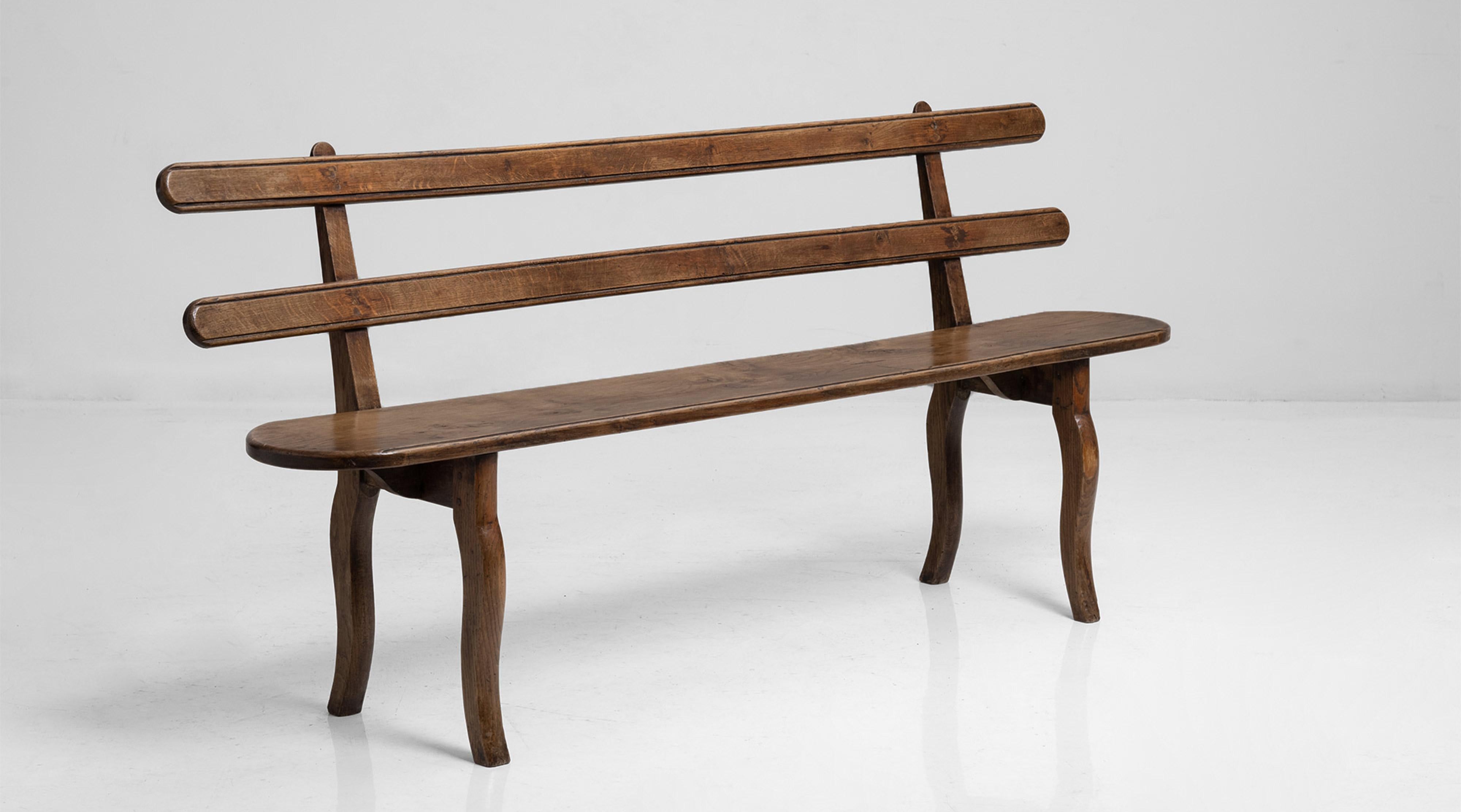 Beautifully made hand crafted bench with fine curves and horizontal back rest bars.