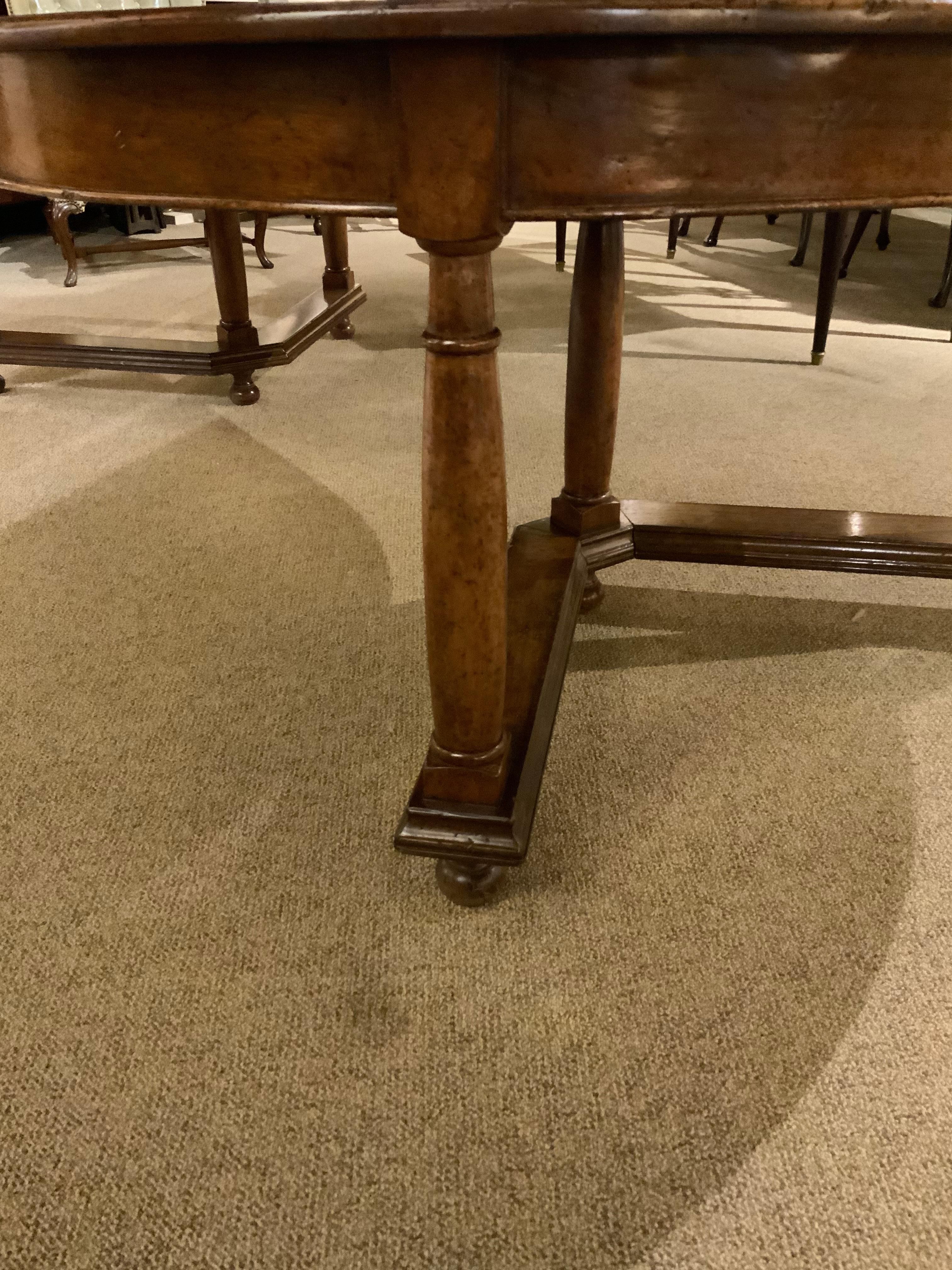 Beautifully constructed and sturdy table raised on shaped legs ending in bun feet.
Two inlays on the top in the form of stars grace the top of this table. It has two leaves
That are removable. The finish is a distressed walnut that makes this
