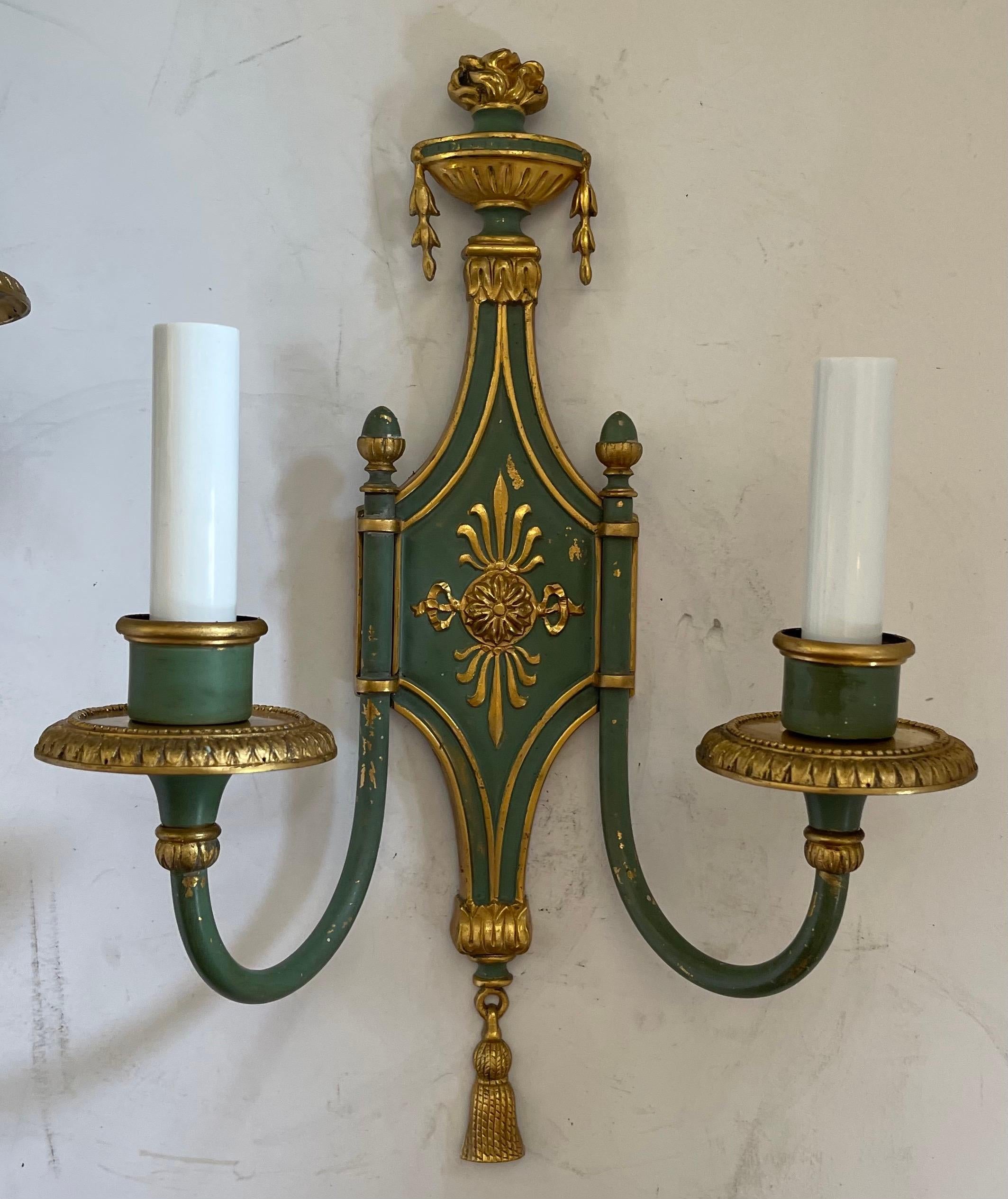 A handsome pair of E.F. Caldwell Adams Regency style urn top green & gold gilt two-light sconces
Rewired and ready to install with mounting hardware.