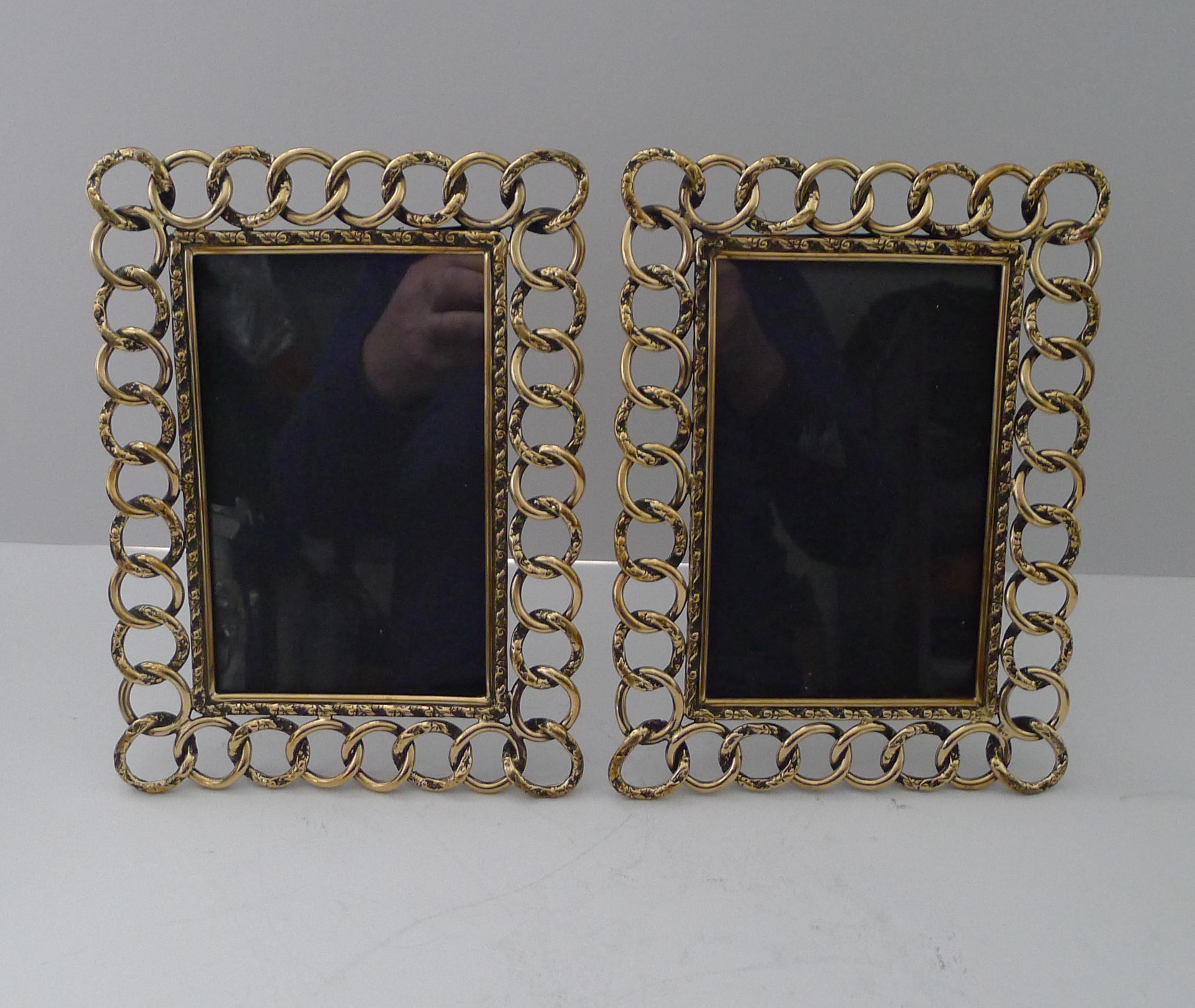 A handsome large pair of English Victorian photograph frame made from a series of intertwined cast brass rings, know as 