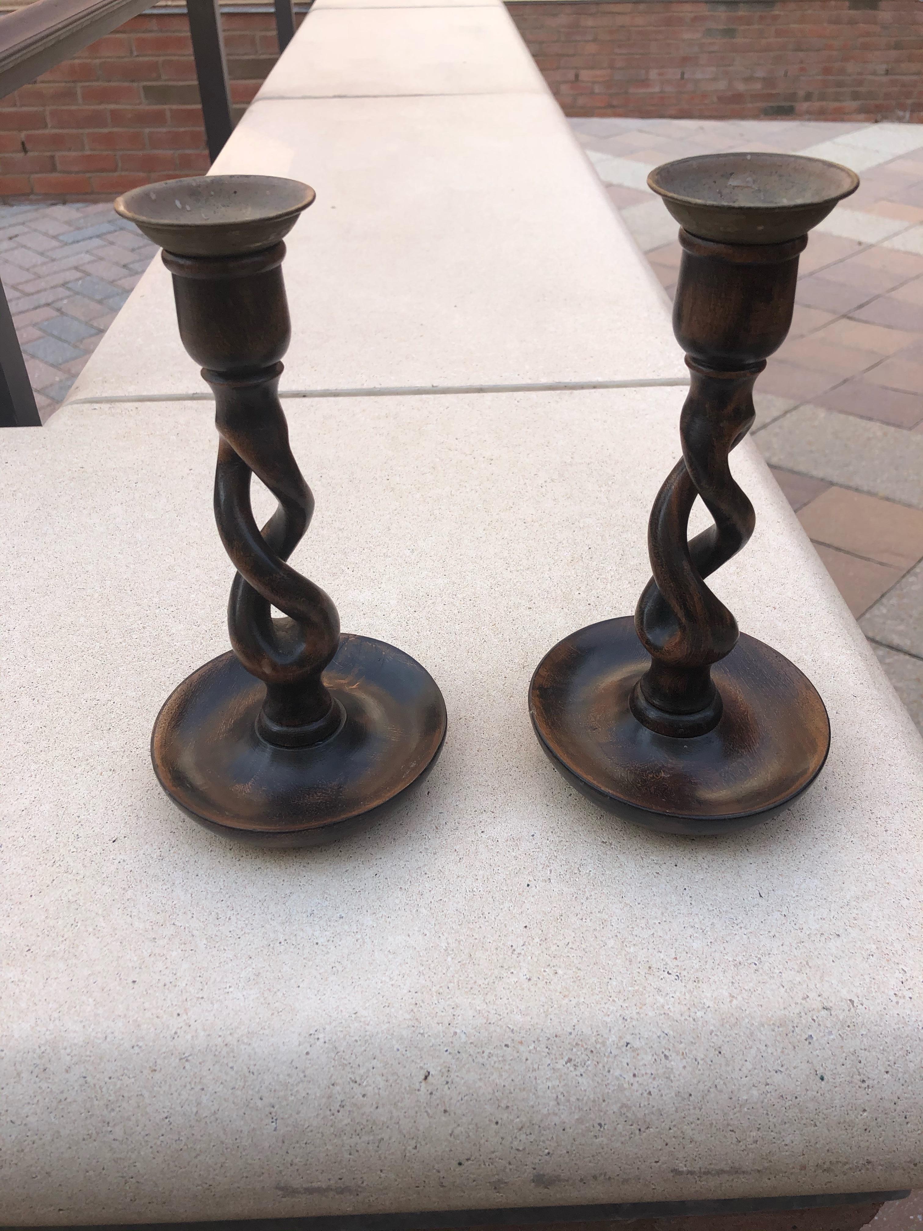 Striking pair of 19th century English oak open barley twist wooden candlesticks topped with brass candleholders. 

  
