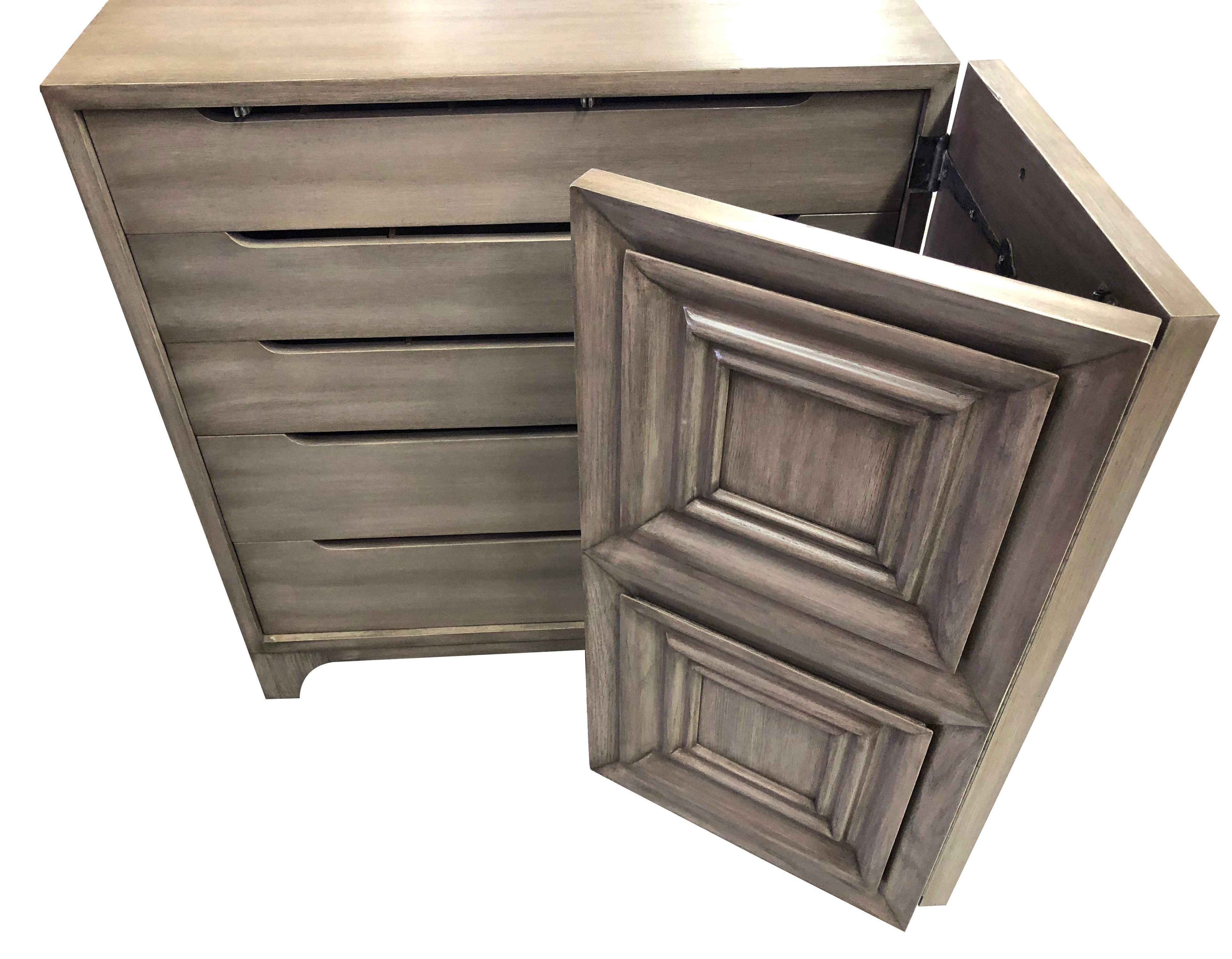 A handsome pair of American midcentury solid grey-cerused oak dressing cabinets with coffered bi-fold doors; each solid cabinet with bi-fold doors adorned with coffered panels opening to reveal 5 long drawers.