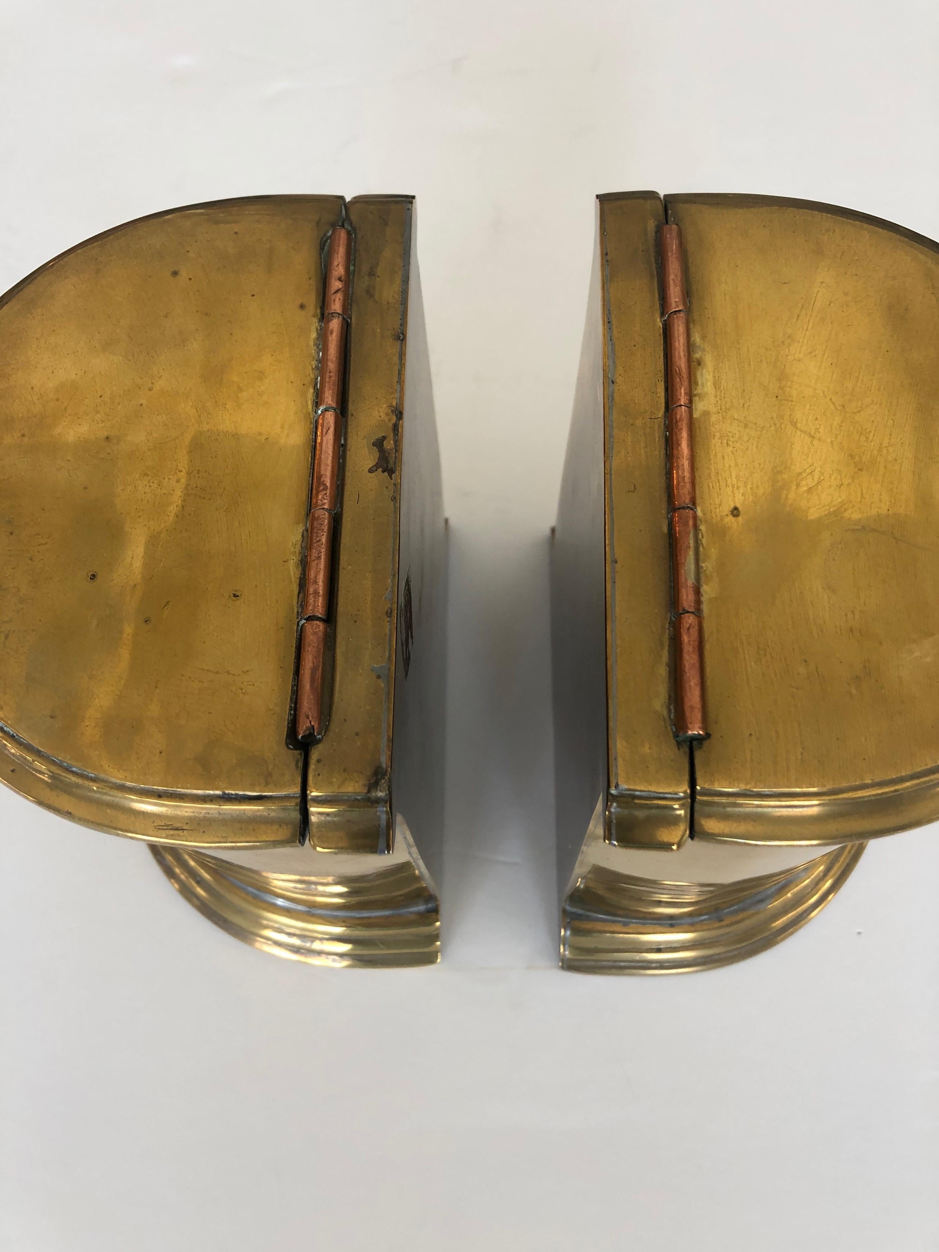 Stunning chunky pair of antique heavy cast brass English bookends having a cylindrical shape and lids that open for storage inside.