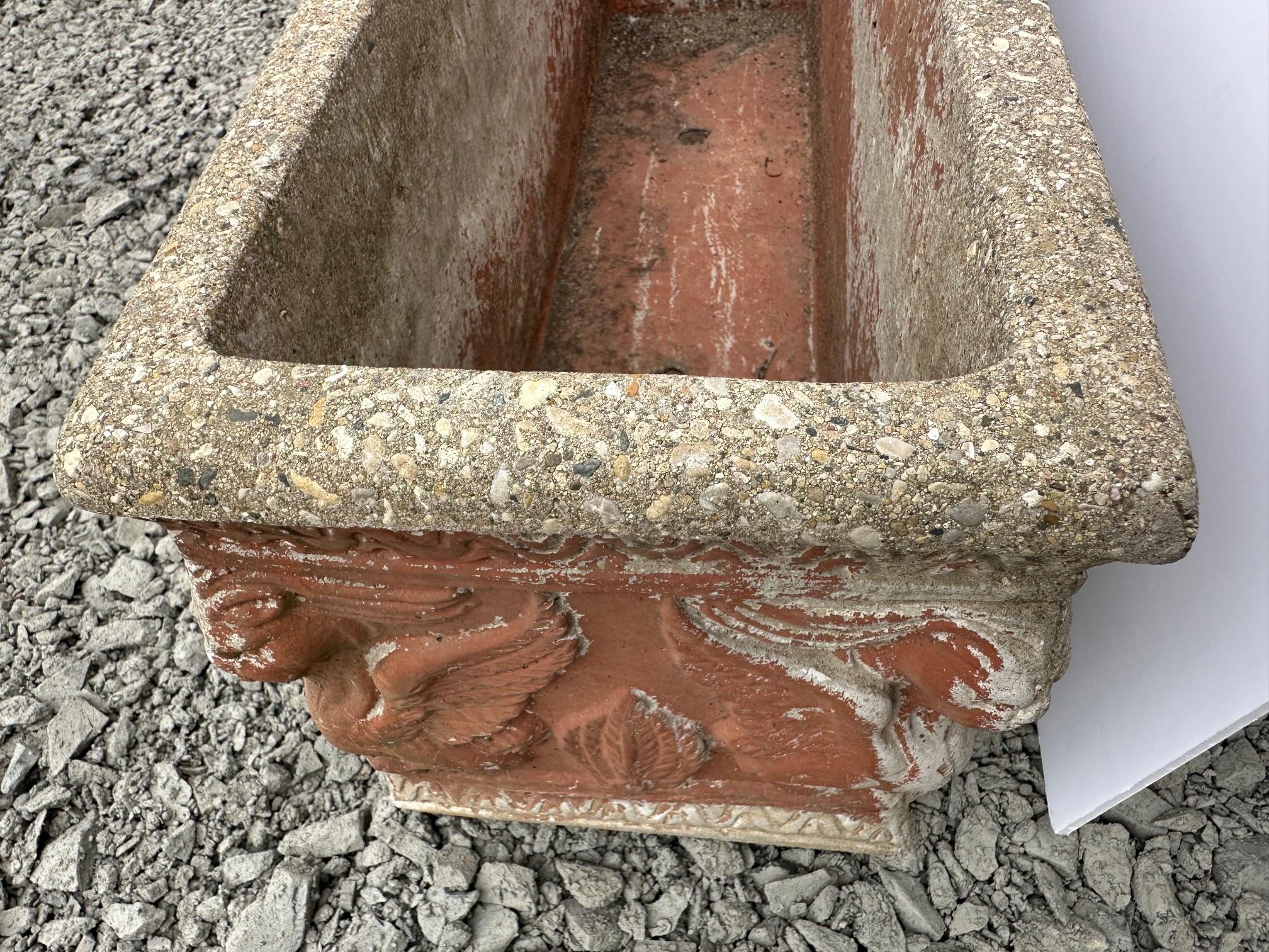 Pair of antique cast stone trough shaped planters having handsome relief decoration on the exteriors.
