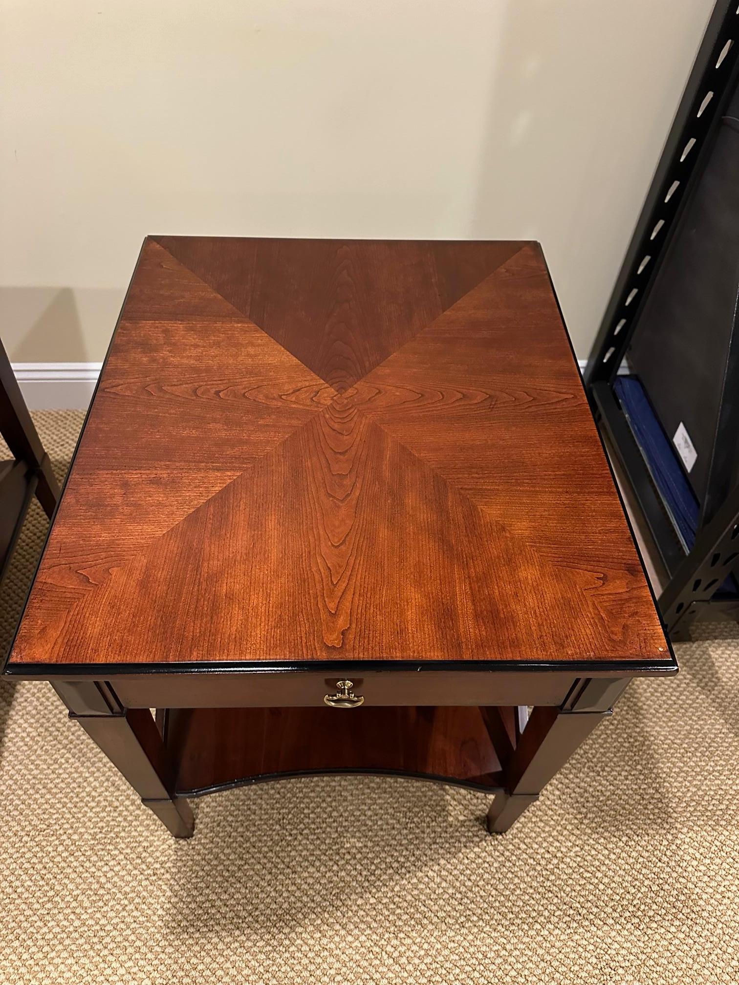 Pair of Hickory Chair wood side tables with ebony accents, front drawer with brass pull and handsome X motif on sides.