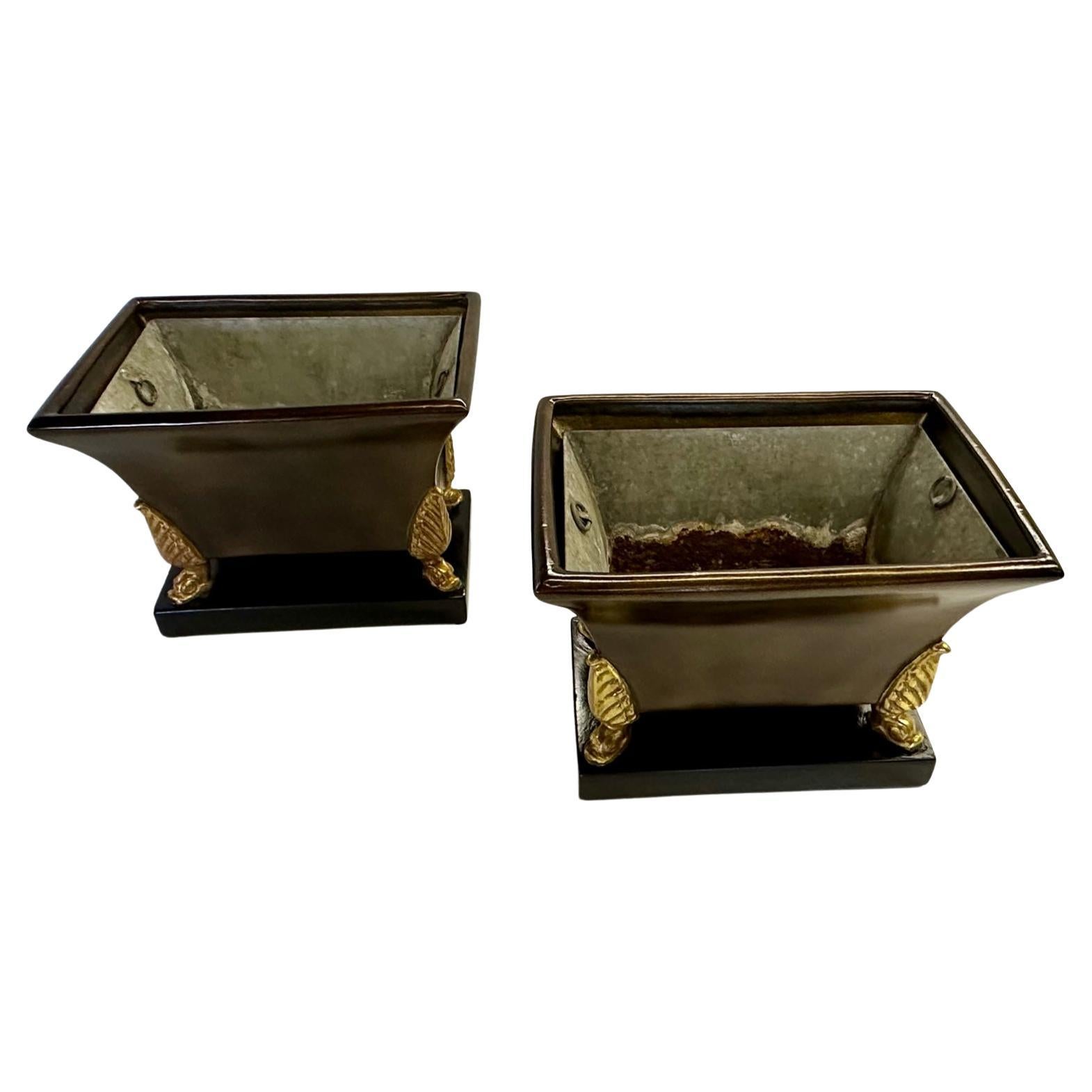 Beautiful pair of vintage Italian Regency style glazed and painted terracotta planters having a warm earthy patina and gilded feet. They each retain original metal liners. Baes are 12.5 x 7.5.