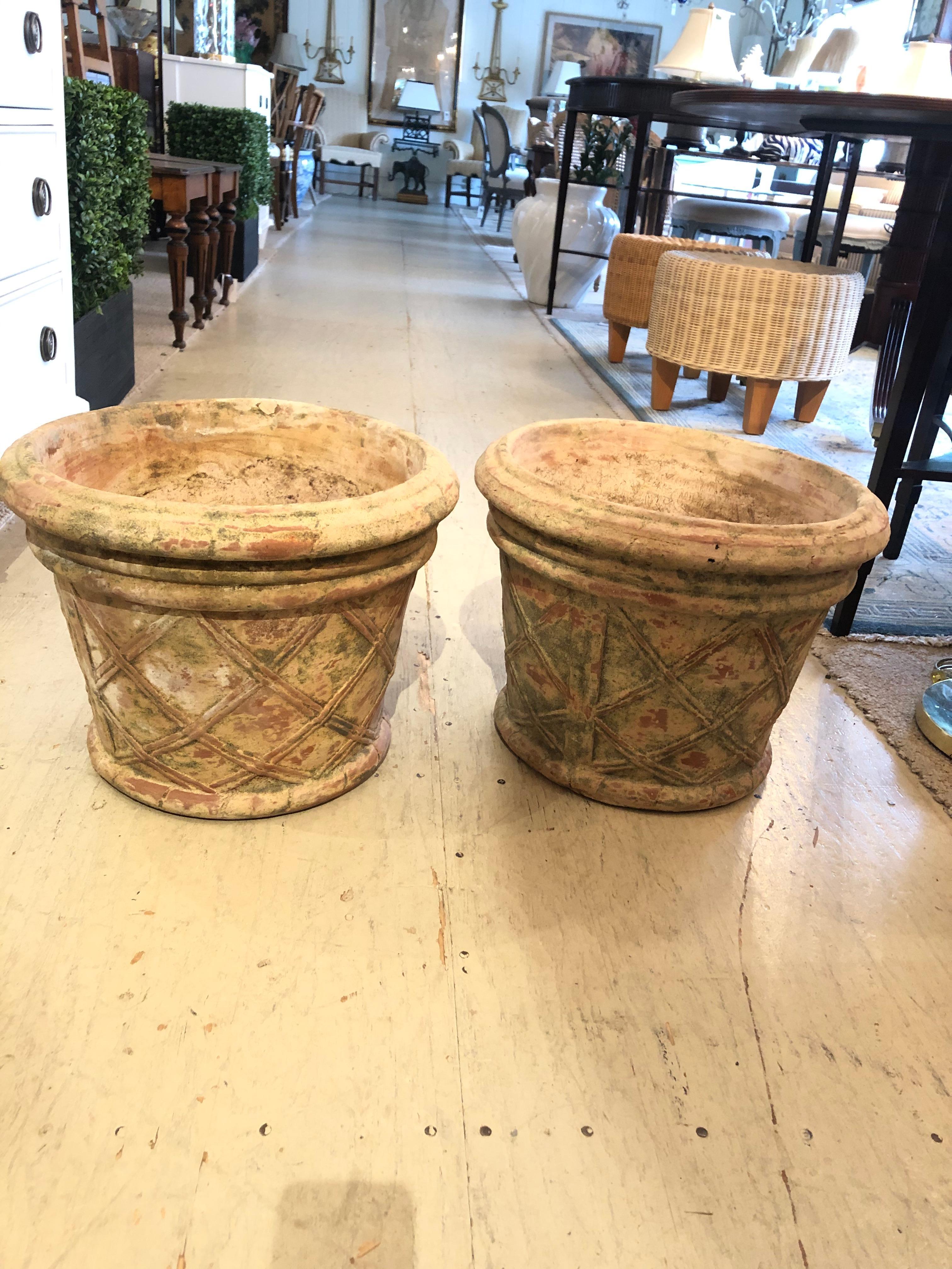 Great looking medium sized terracotta urns having relief lattice design and wonderful natural aged coloration.