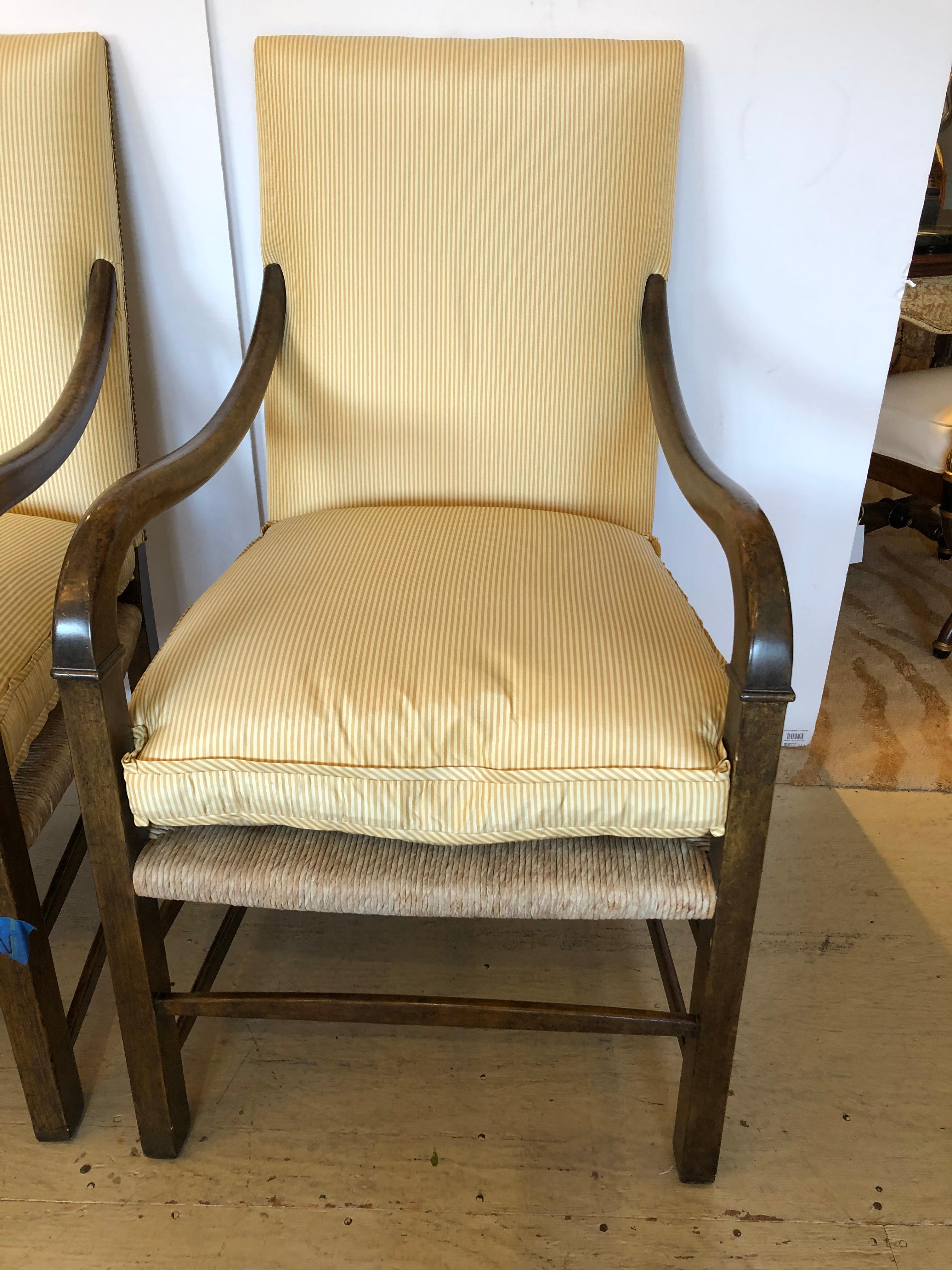 Great looking pair of designer armchairs having rich wooden frame, rush seats, and Nancy Corzine's signature striped upholstery. Handsome window pane backs.
Measures: Arm height 27.5
Seat depth 22.5.