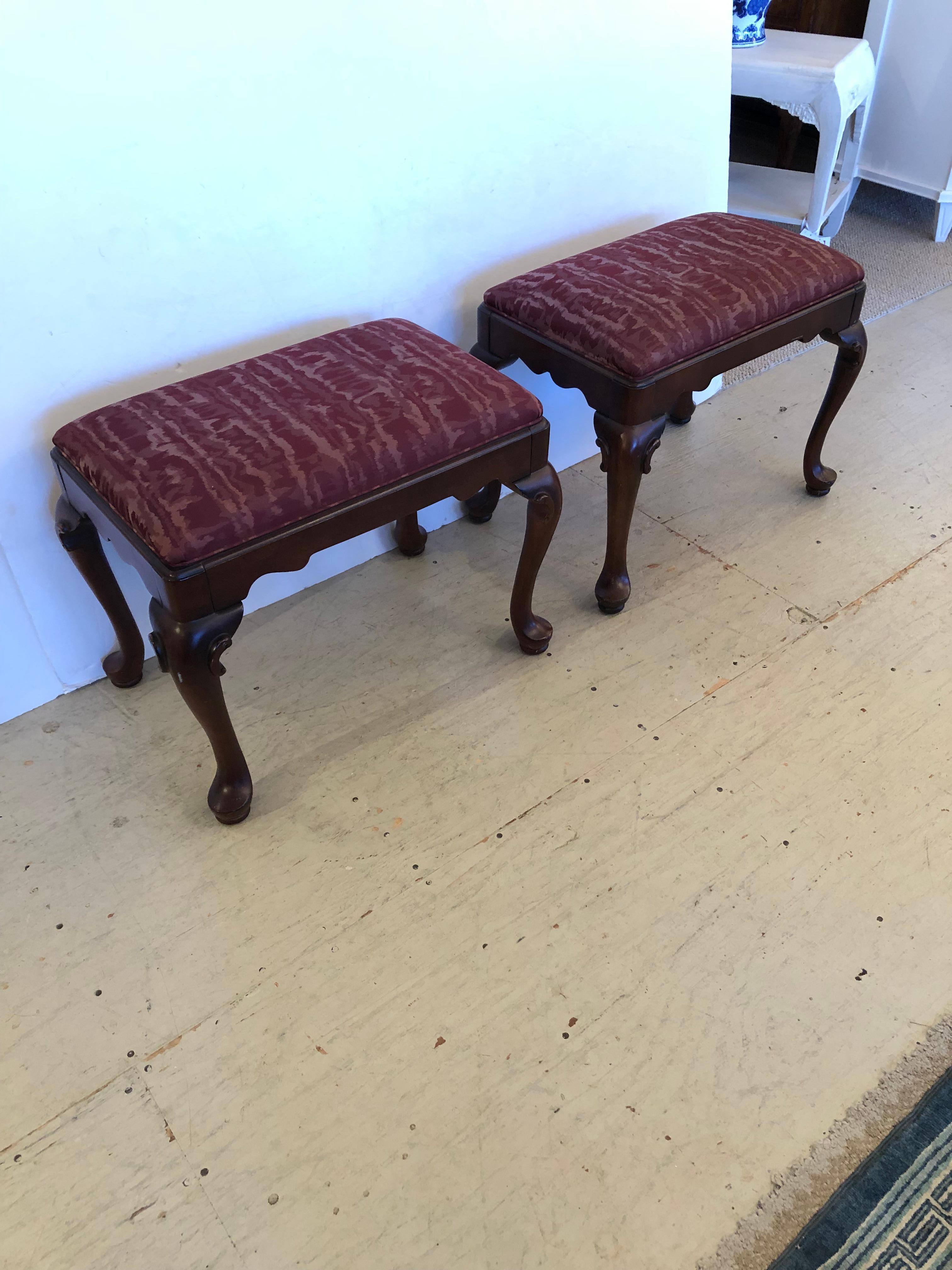 Classic pair of rectangular Chippendale style ottomans footstools having mahogany bases with carved cabriole shaped legs.