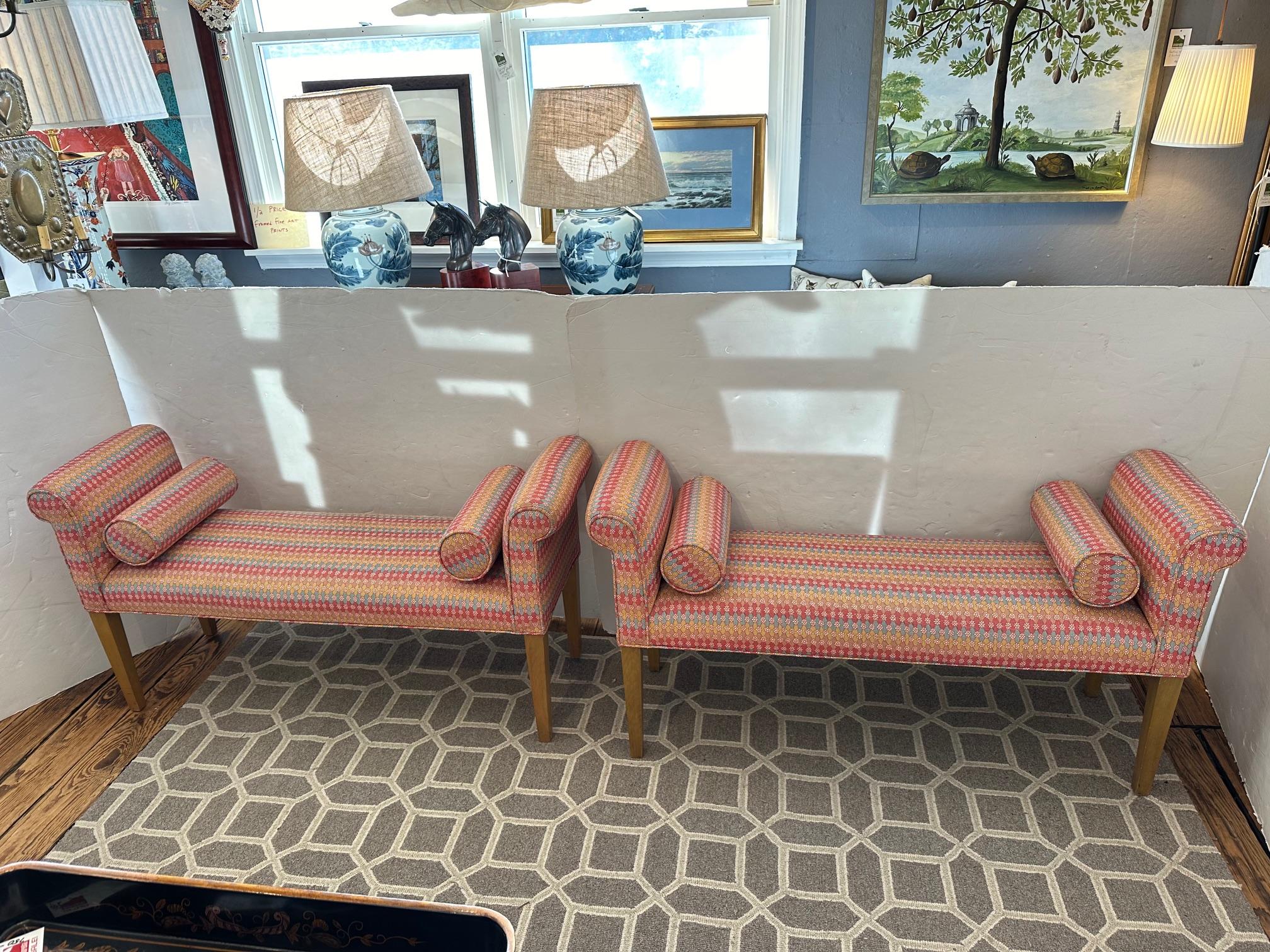 Great looking pair of upholstered contemporary benches with wooden tapered legs and bolster pillows.