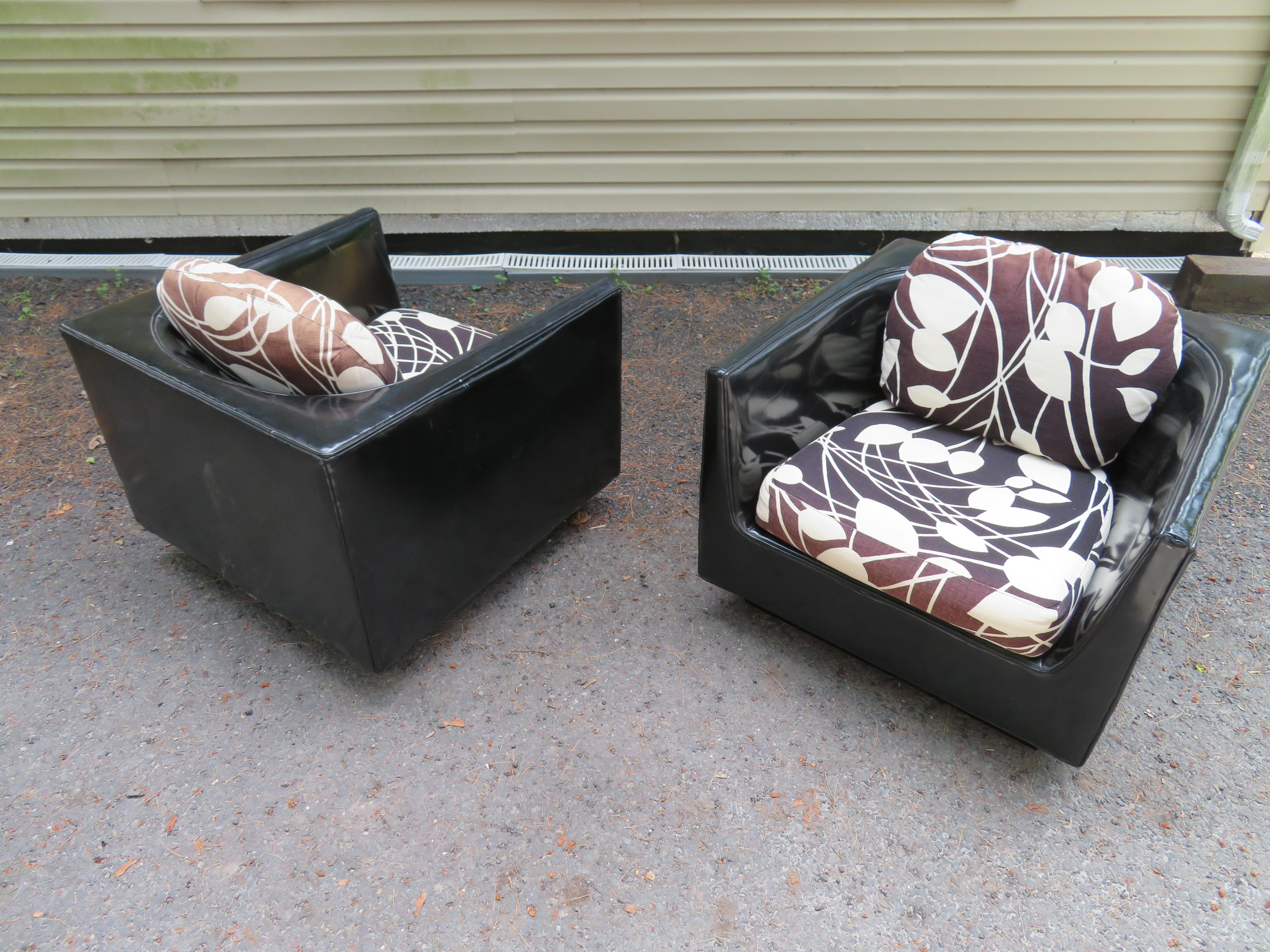 Handsome pair of signed Selig cube lounge chairs in they style of John Van Koert. We love the unique curved u-shaped backs along with the original black and white linen seat cushions. The original upholstery does show wear with some fading to the