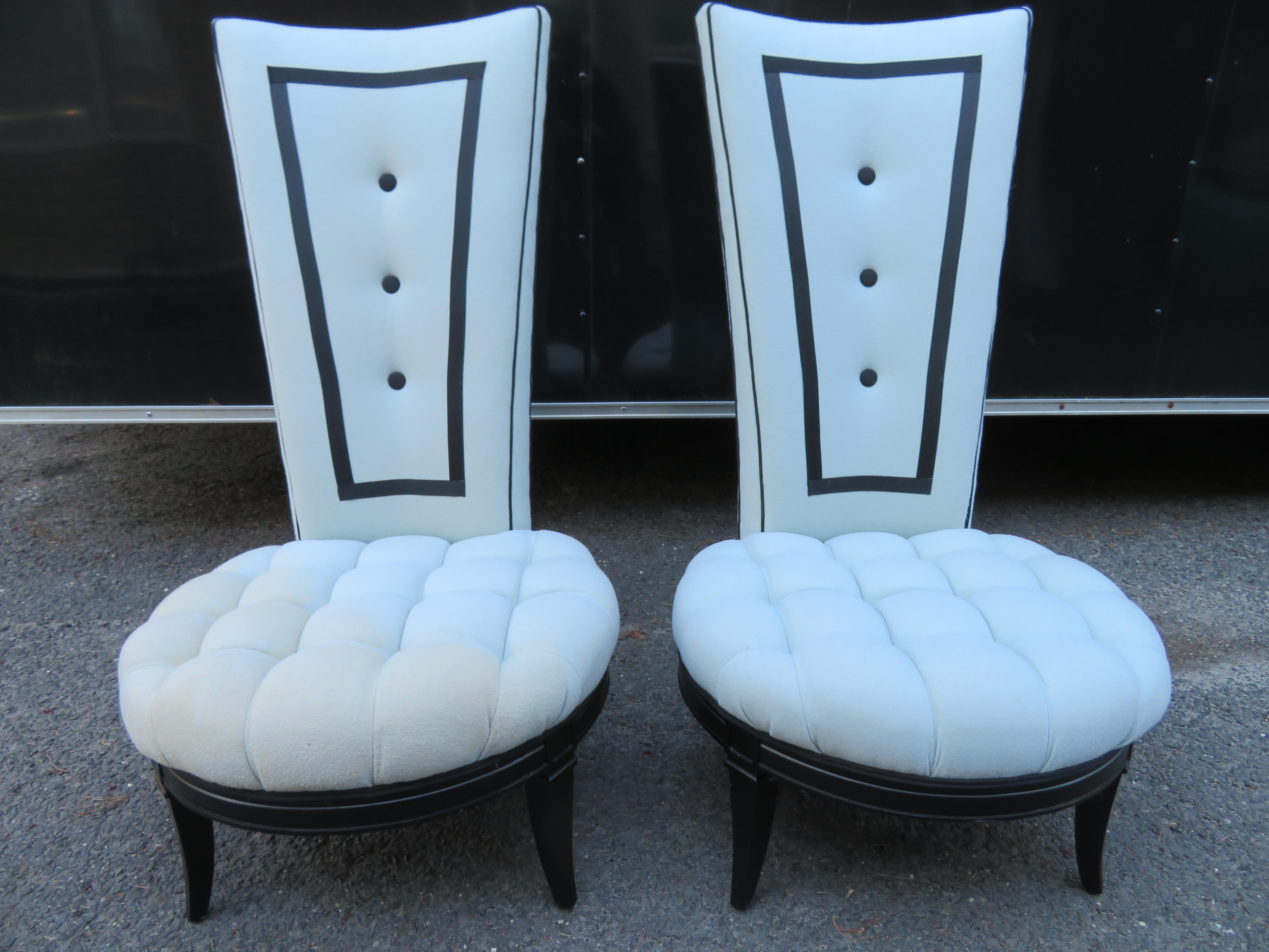 Handsome pair tuxedo style tall back slipper chairs with gorgeous wide tufted seats. These were re-upholstered about 10 years ago by a high end designer and the frames were lacquered black. One chair shows more wear than the other with spot and
