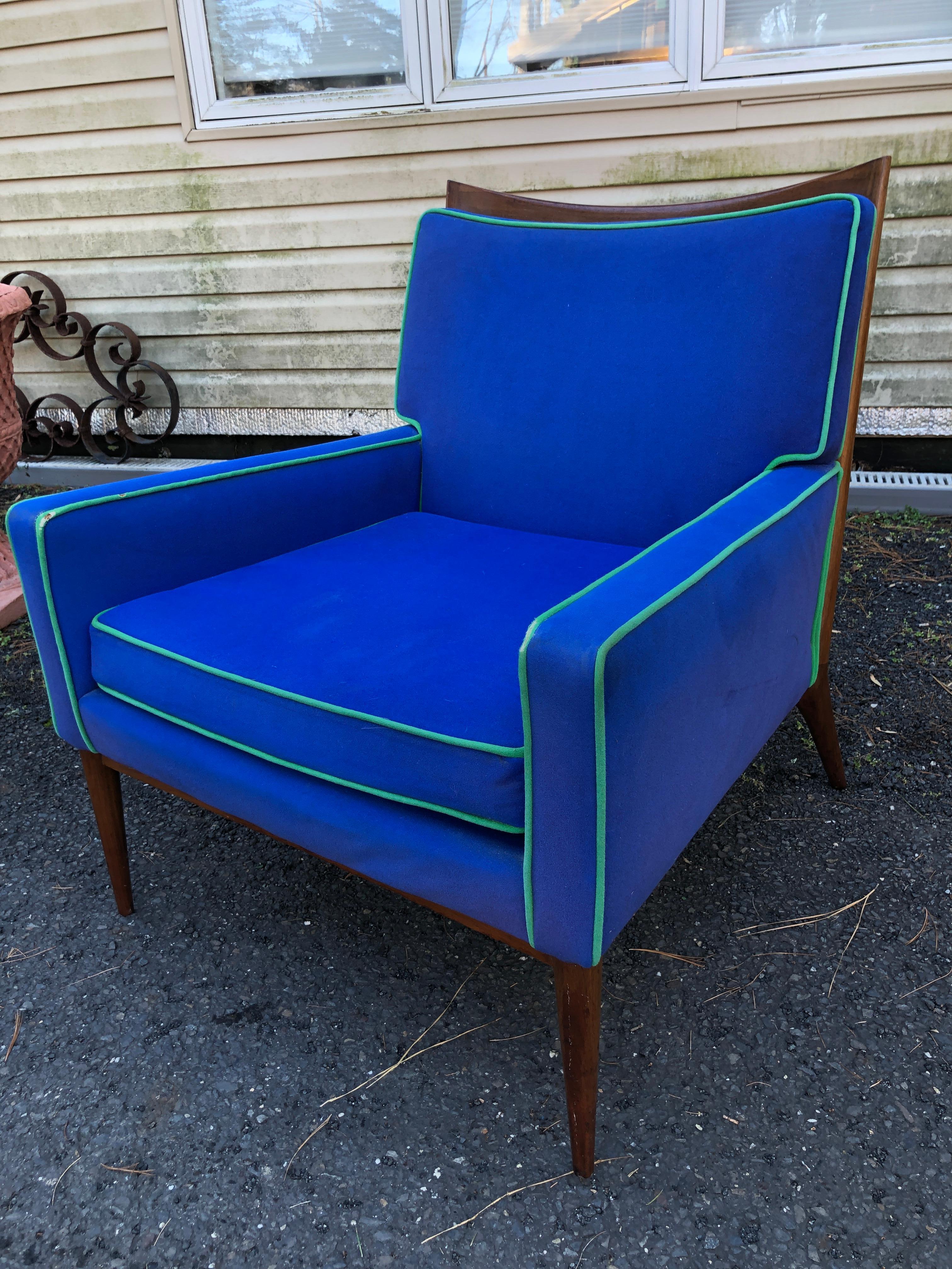 Paul McCobb for Directional Furniture 1322 lounge chair, loose seat cushion. Circa 1950s. Featuring a curved top rail walnut frame, tapered legs and comfortable curved and cushioned back.  This chair will need to be reupholstered but the cushions