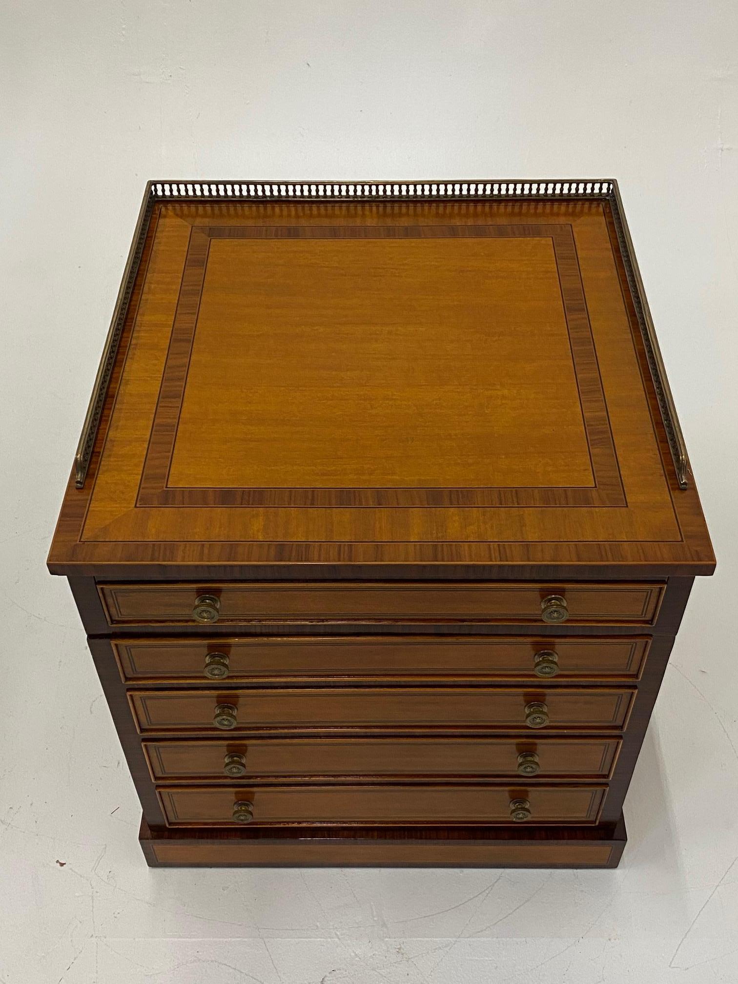 Versatile Regency style mahogany and satinwood inlay cabinet having brass gallery surround, single drawer on top of swing out door with faux drawer decoration. Opens to reveal storage inside. 
25 H to top w/o gallery.