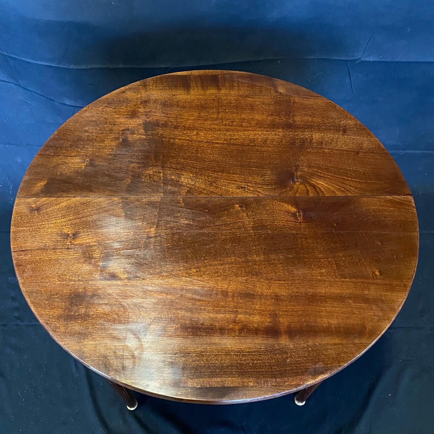Beautiful brass mounted round Louis XVI French walnut side or entry table, having many uses : as a side table or nightstand, or as an entry table as a focal point. Bought in Lyon, France. 
H skirt 25”

#4978.