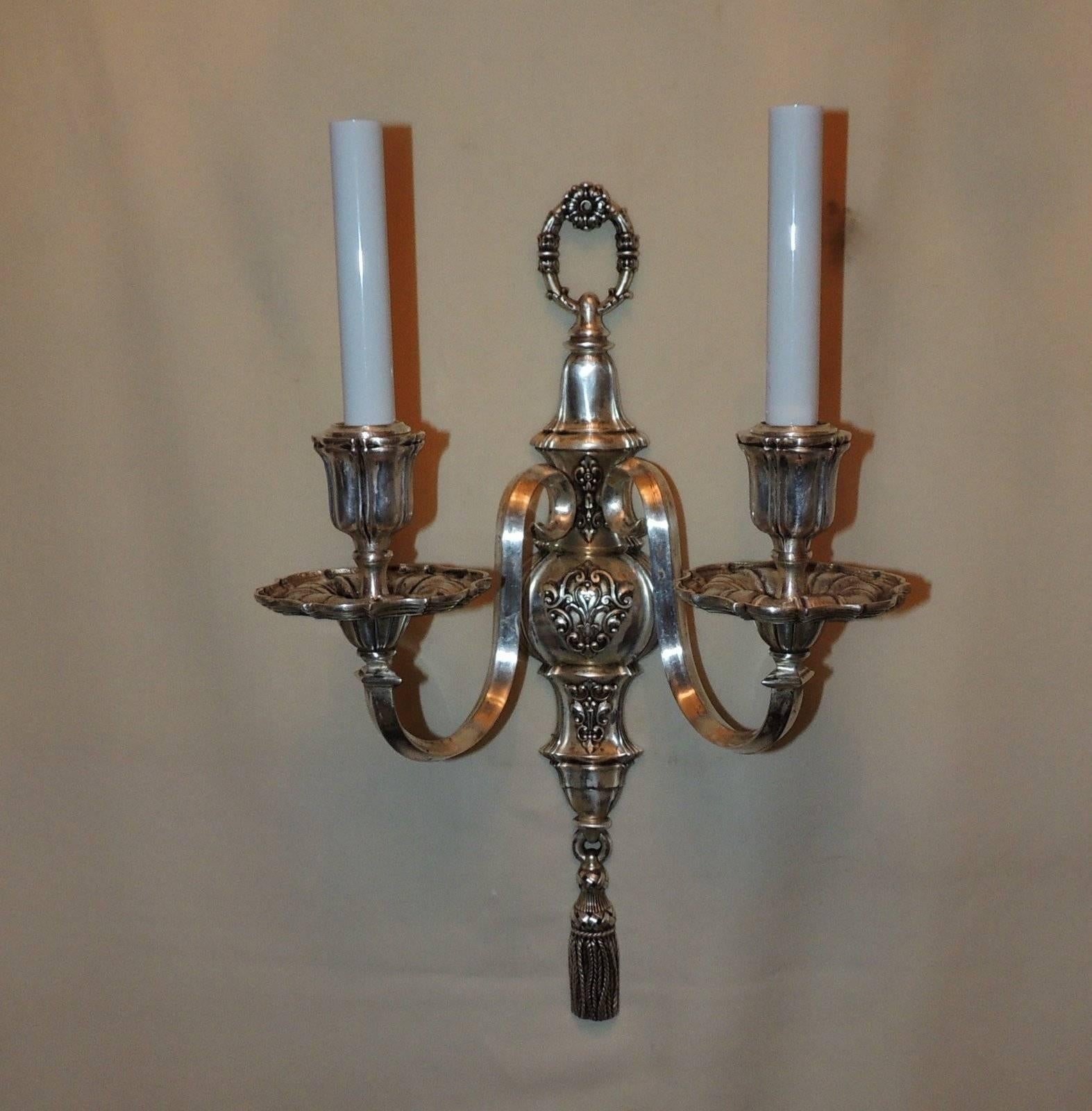 A handsome pair of stamped E.F. Caldwell silvered bronze, nickel-plated tassel Regency two pair of sconces with two arms, beautiful details on candle cups and bobe`ches,
completely redone with new wires and sockets, come ready to install.

Measures: