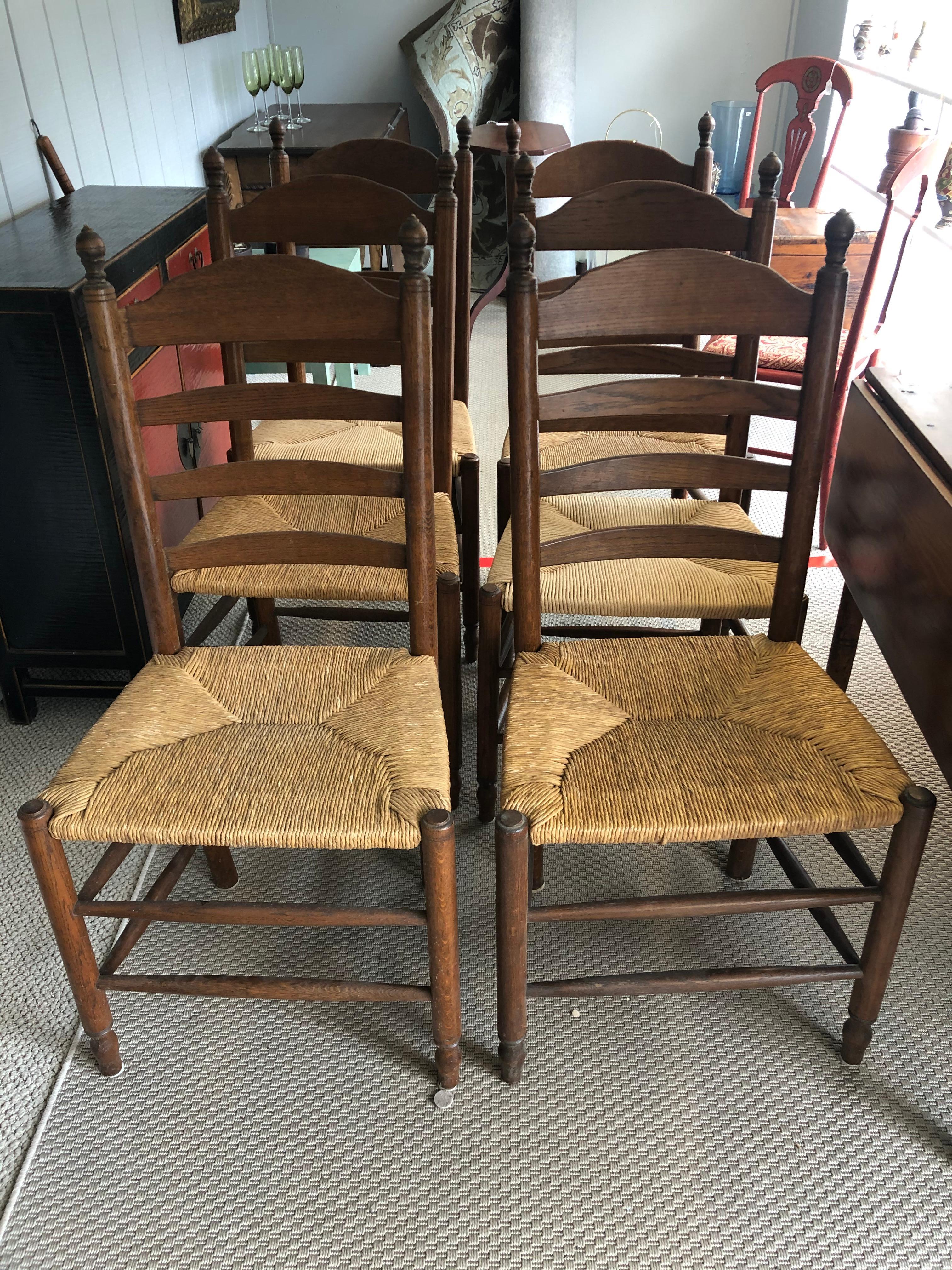 A handsome set of 6 classic Vermont ladder back side dining chairs having charming rush seats.