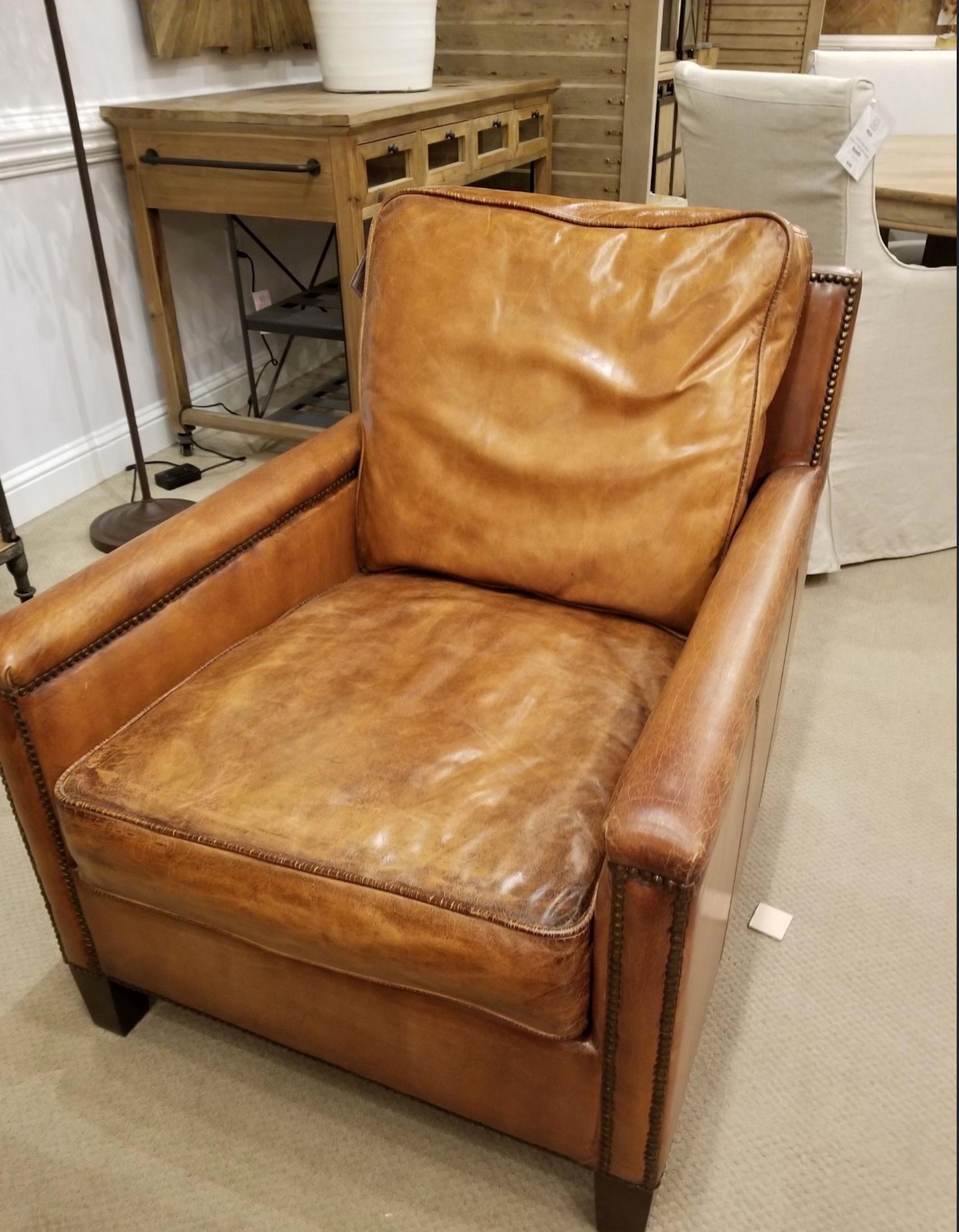 Handsome set of four English library style club chairs with lovely worn patina and nailhead trim. Great scale for comfort. Priced per chair.
     