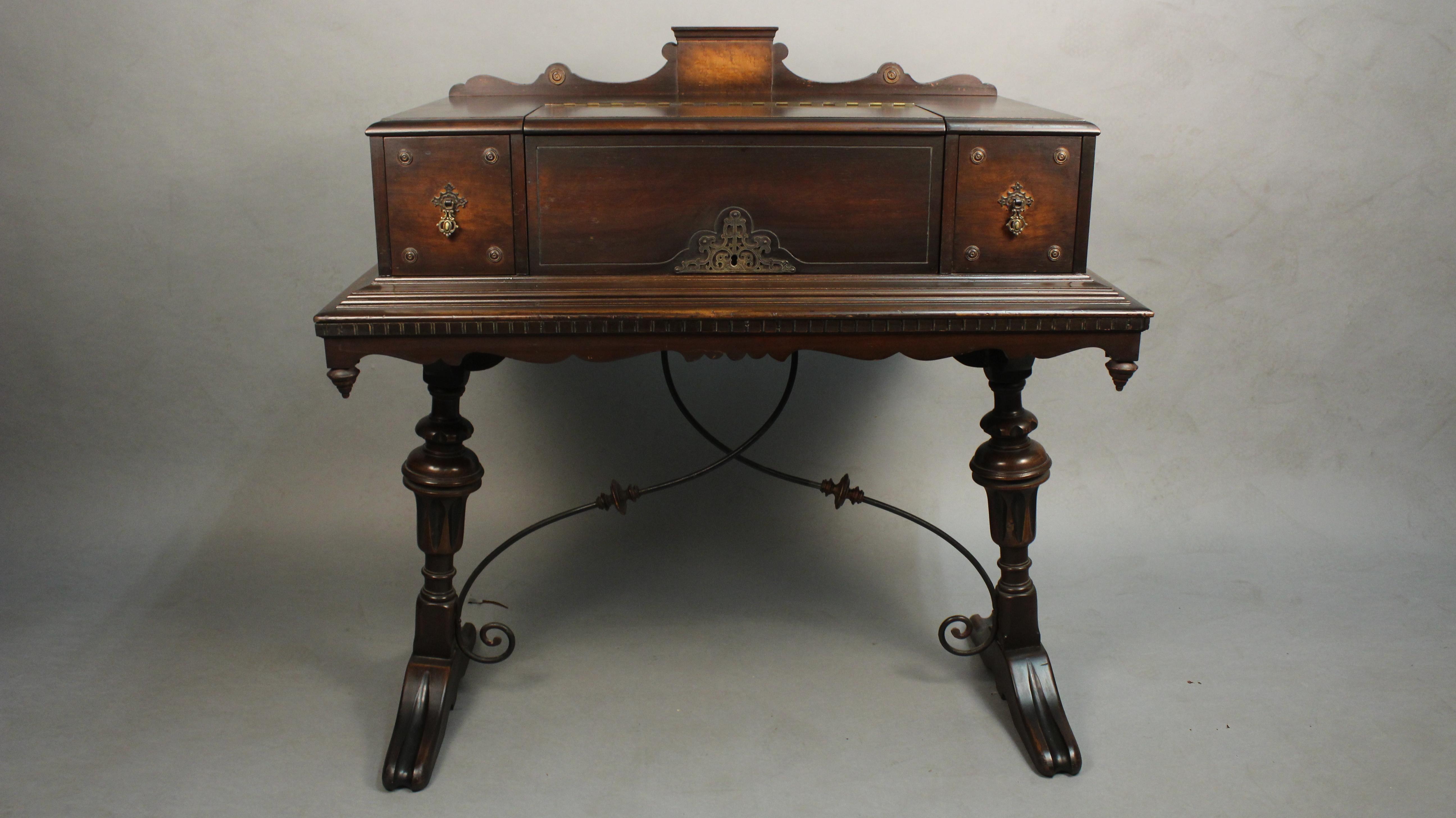 Walnut writing table with splayed legs and iron stretcher, circa 1920s. Original finish. 40