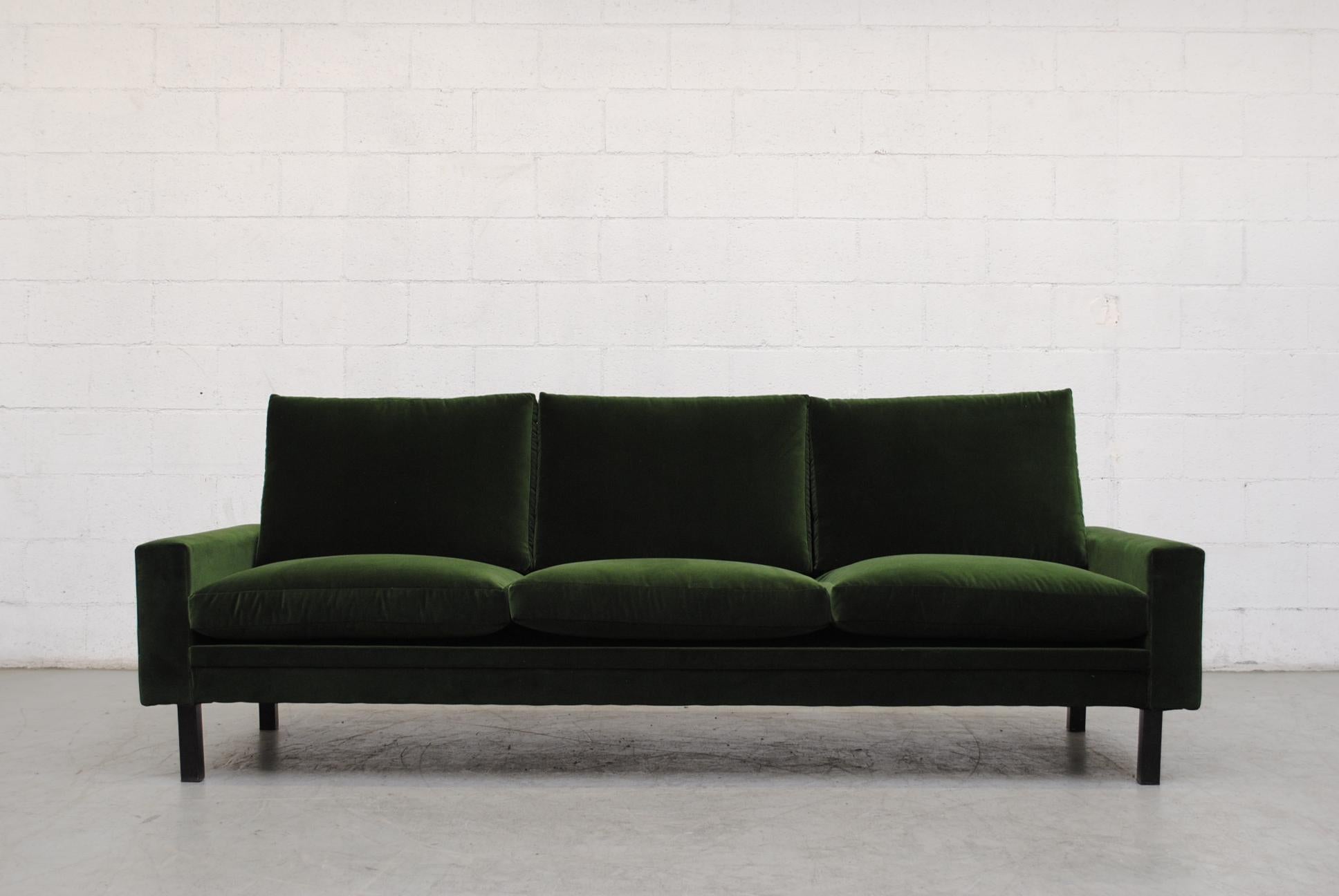 Handsome midcentury 3-seat streamlined sofa upholstered in emerald green velvet, minimal wear. Legs in original condition. Stunning!