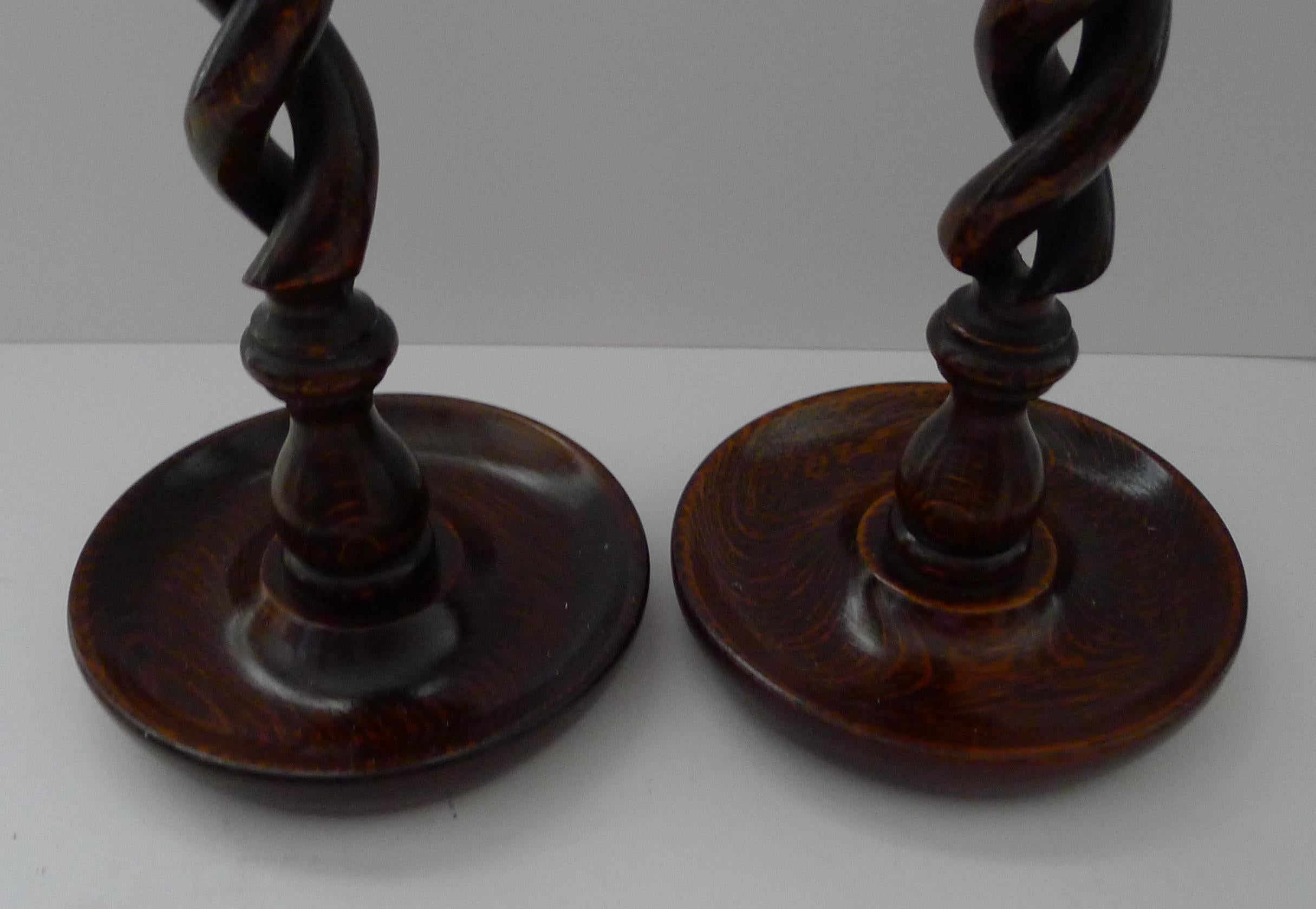A particularly fine pair of antique Oak candlesticks, and with much skill were lovingly carved, with an open barley twist design.

The tops have decorative brass tops, a winning combination with the rich coloured Oak.

Taller than most towering 14