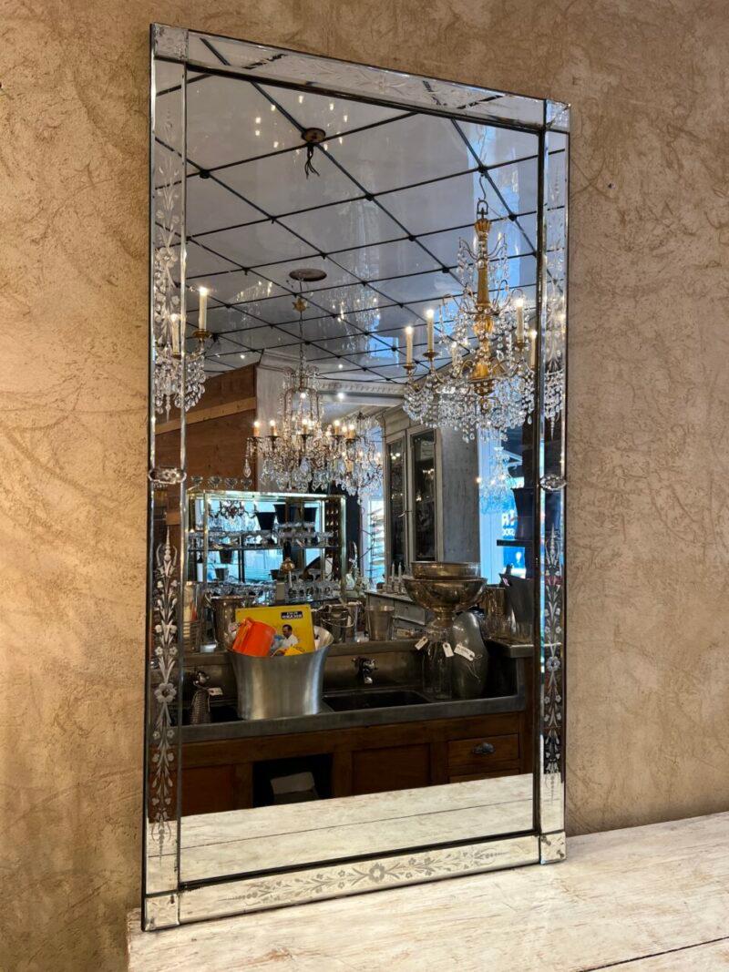 Magnificent mirrored wall mirror in Venetian style from around 1930s-40s France. Rectangular in shape and can be hung either horizontally or vertically, as desired.

Note the beautiful patina in the glass, and the lovely faceted and floral