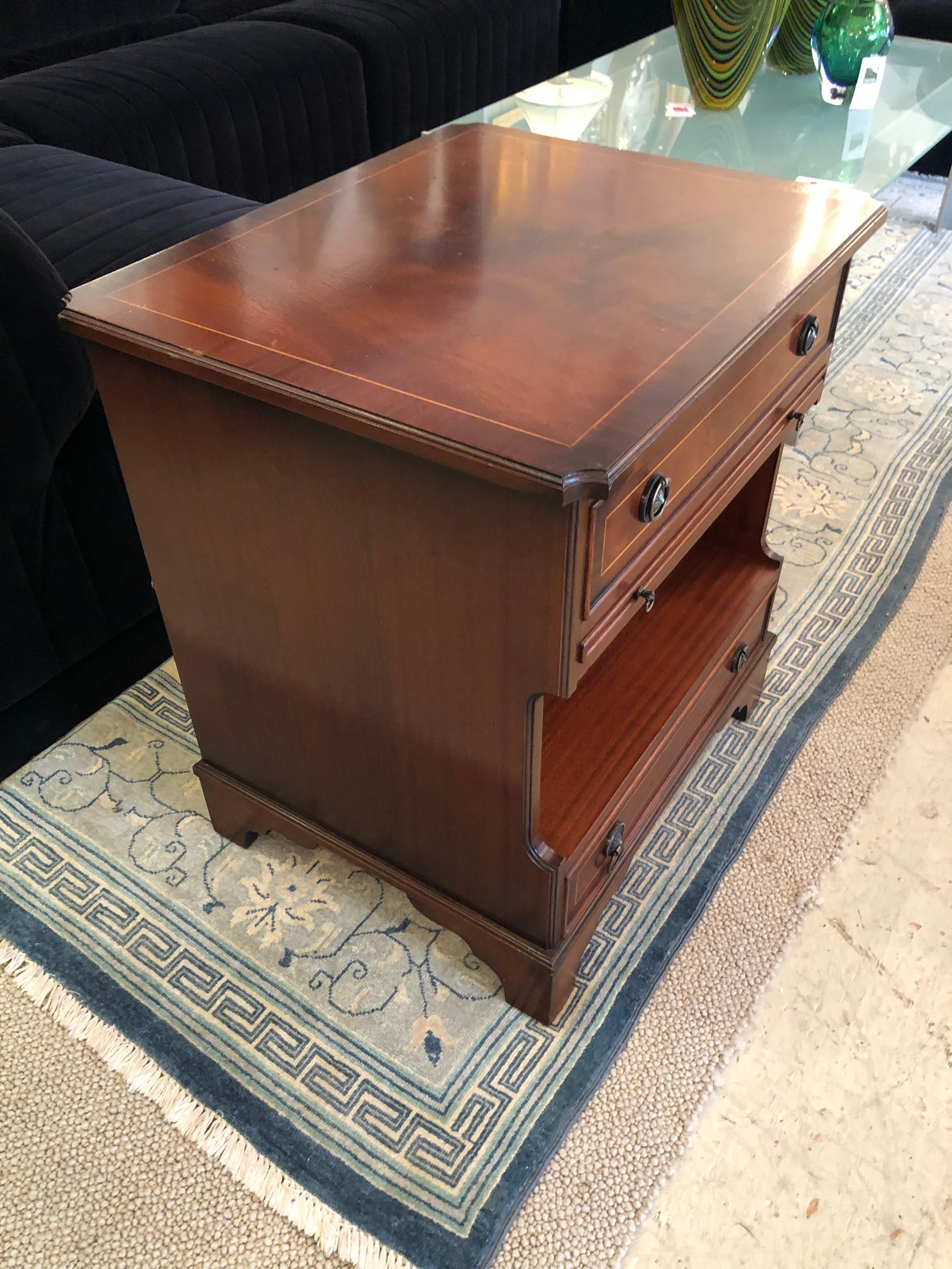 Elegant vintage mahogany night stand having wonderful shape with top and bottom drawer, slider that pulls out under the top drawer, and open storage area above the lower drawer.  Brass handles and lovely satinwood inlay.