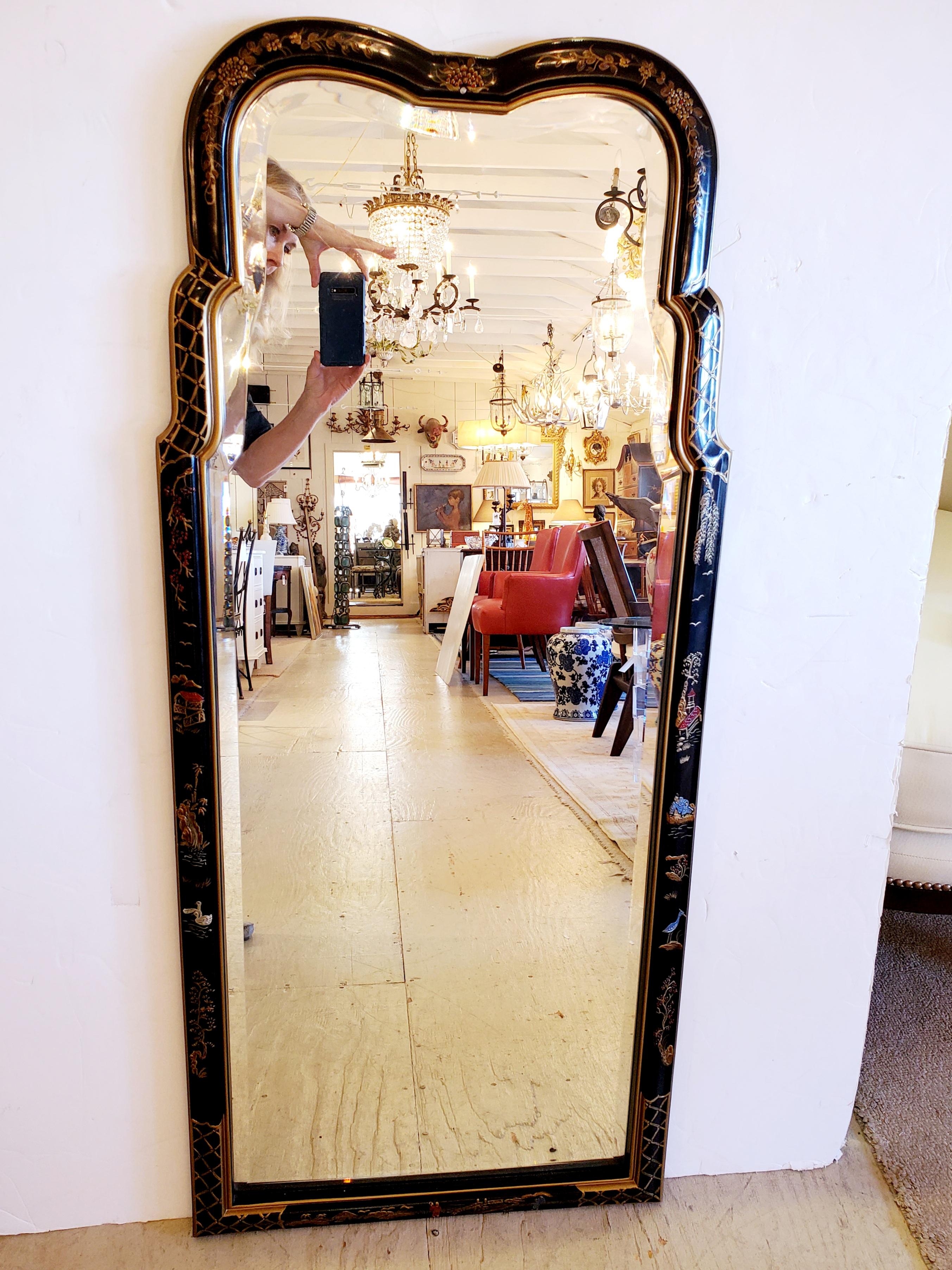 A gorgeous vertical chinoiserie mirror having black background with lovely gold and red decoration.