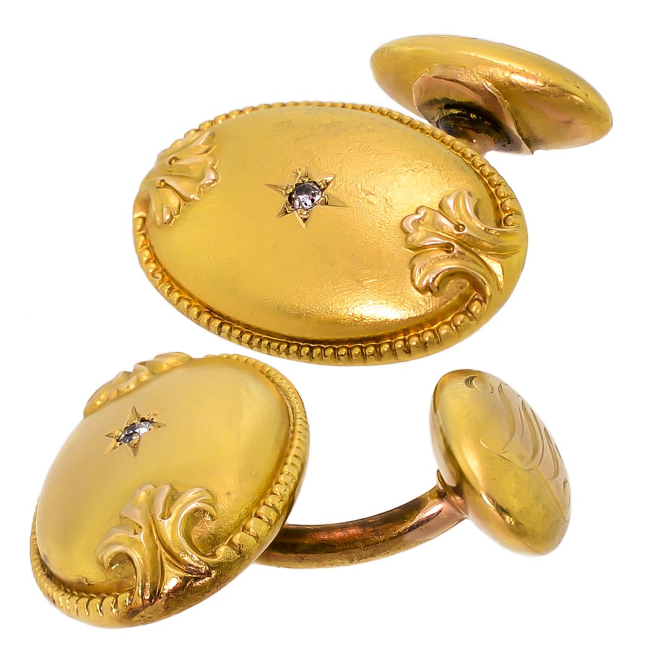 These exquisite oval Victorian 18k yellow gold and diamond cufflinks are handsome and tailored and exhibit elegance, style, and confidence with their simple design. The oval textured front is decorated with a rippled border that leads into an