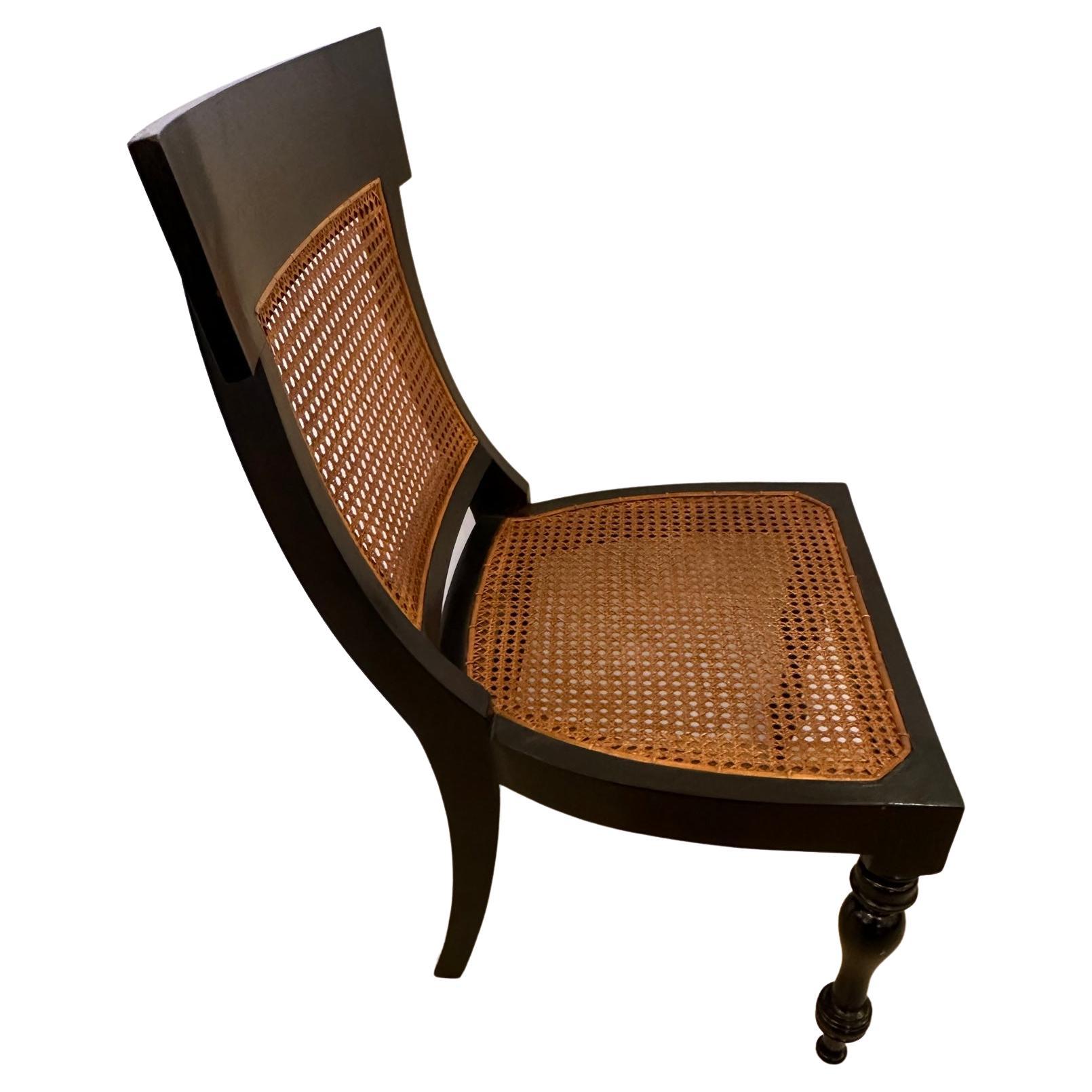 Great looking side or desk chair with roomy proportions mixing an ebonized wood body and rich brown caned back and seat. The back has an elegant curve and the front legs are sculpted.
Note: matching armchair is available.