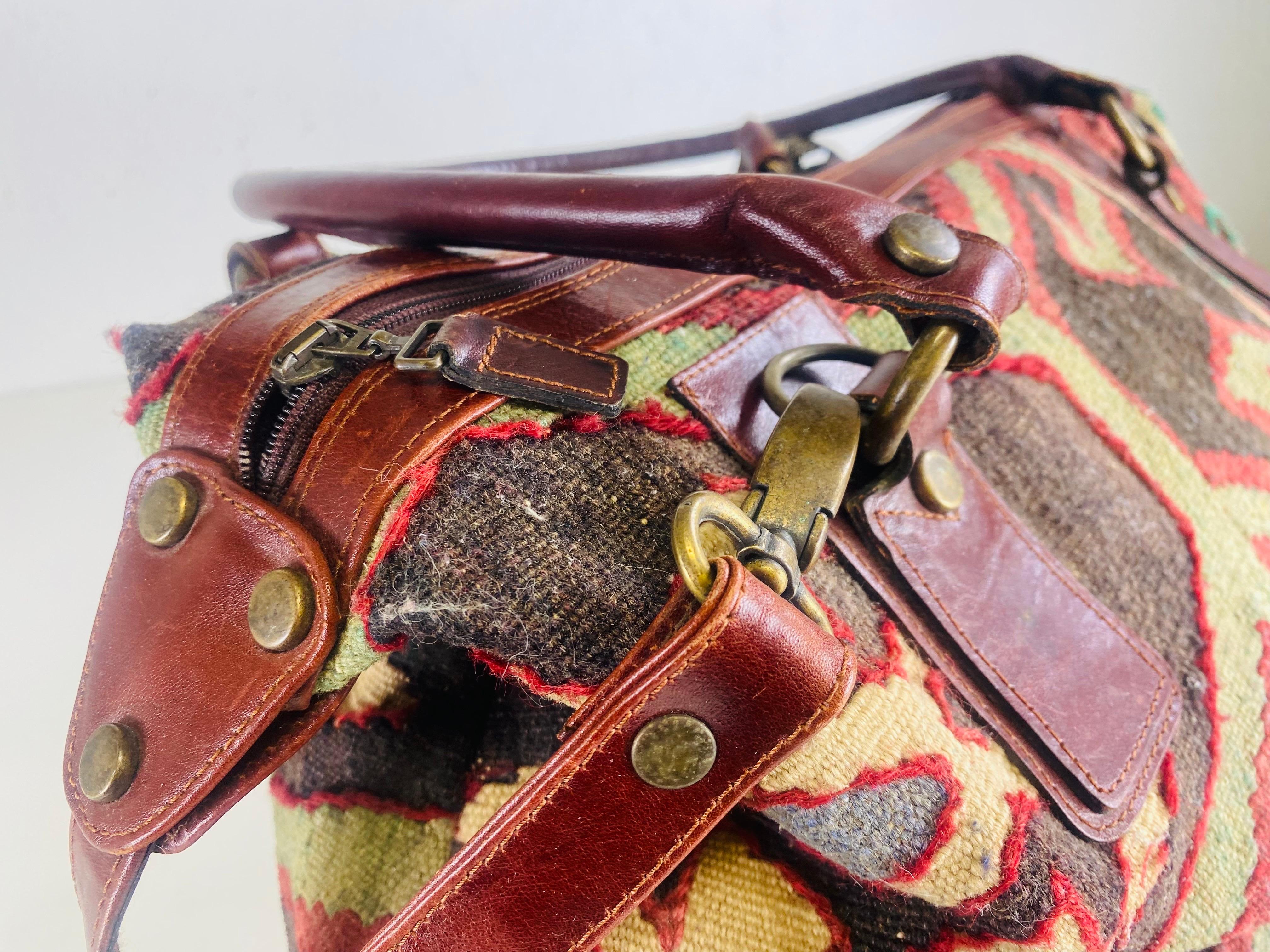 Dies ist ein Ende des 20. Jahrhunderts hübsch Killam und Leder Schulranzen. Diese Handtasche ist aus einem hübschen Killam-Teppich in den Farben Burgunder, Braun und Grün gefertigt. Der Schulranzen hat bordeauxfarbene Lederriemen und Griffe.