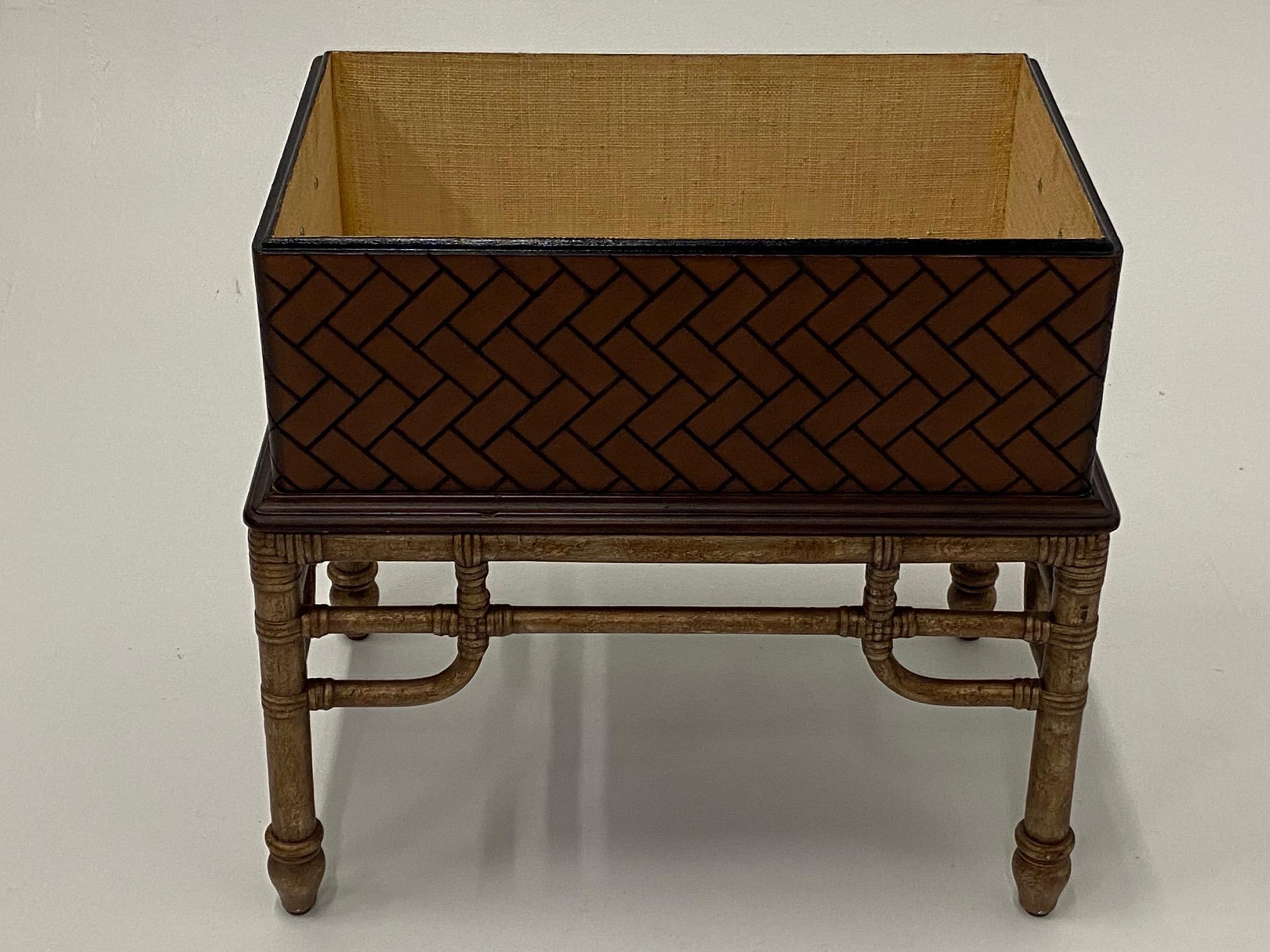 Handsome wooden box in a woven motive that sits on a bamboo stand, lined in linen with removable lid.