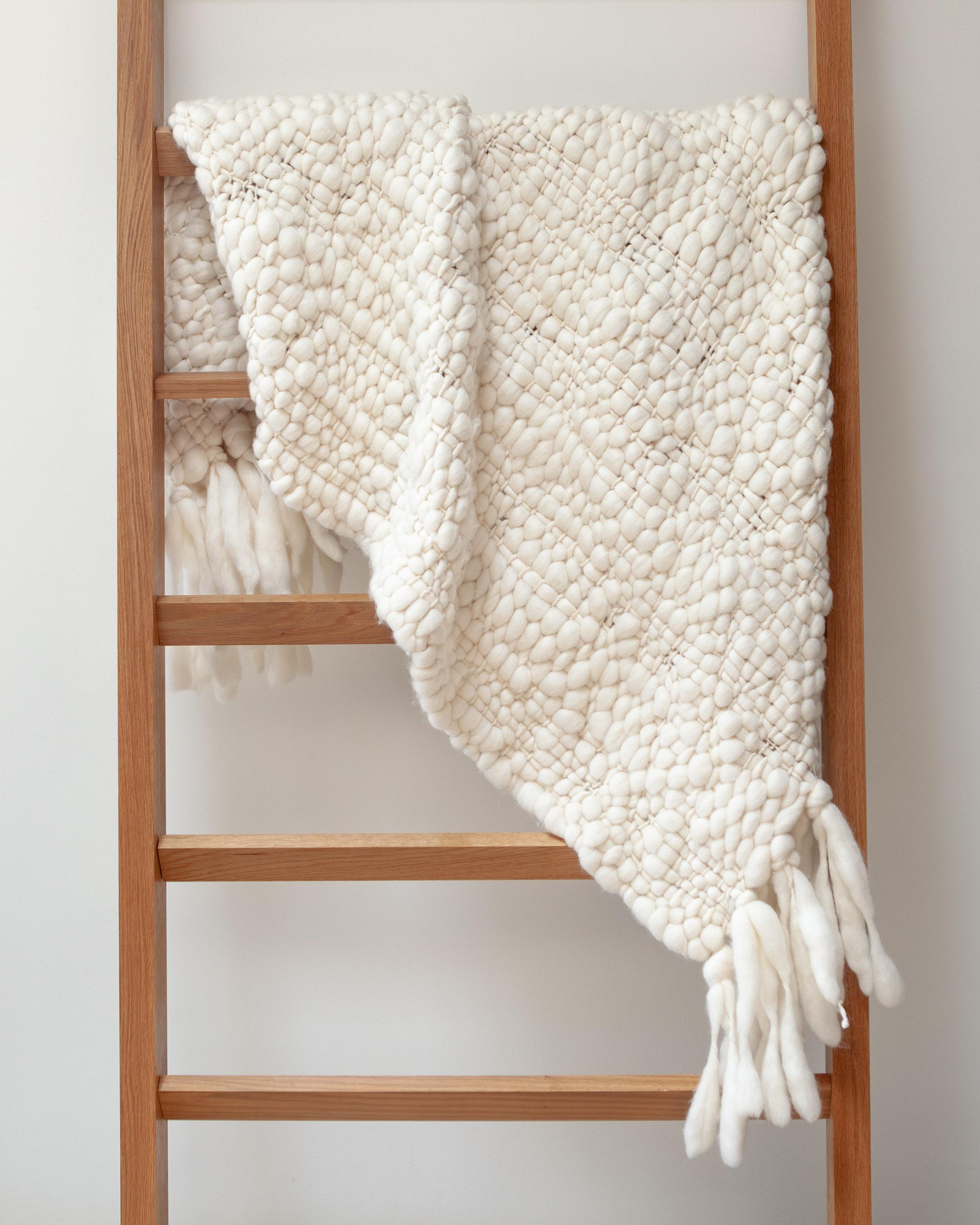 This 100% baby merino organic wool throw is heavenly soft and with a large open weave that creates a unique texture, making it warm and cozy and highly decorative as well. It's the perfect cruelty free non fur alternative to lambskin pieces that are