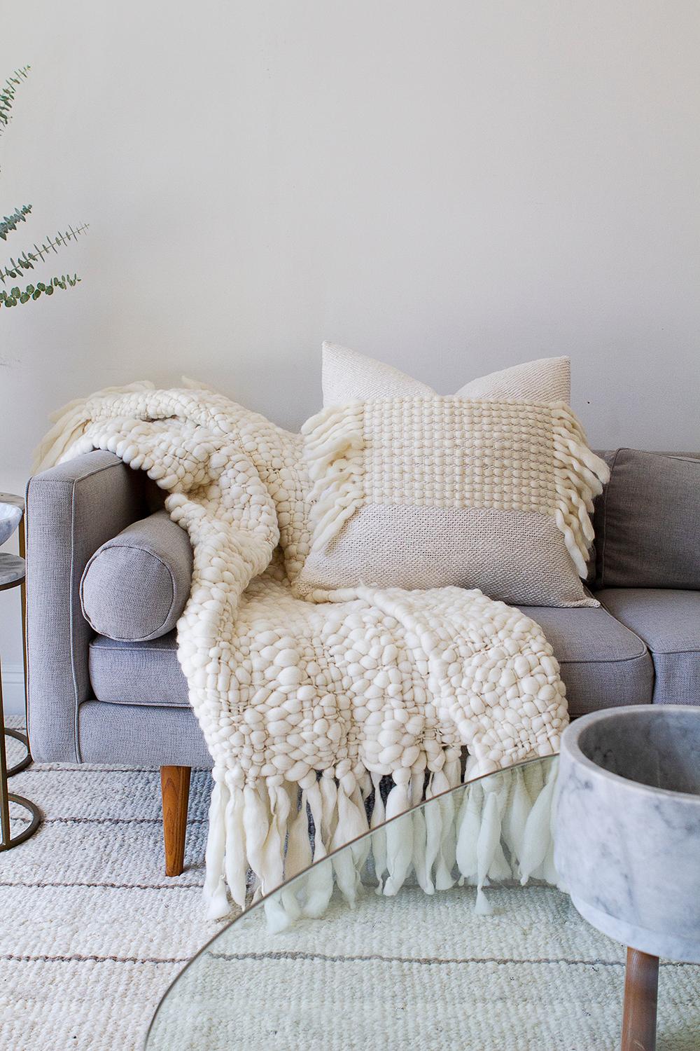 This 100% baby merino organic wool throw is heavenly soft and with a large open weave that creates a unique texture, making it warm and cozy and highly decorative as well. It's the perfect cruelty free non fur alternative to lambskin pieces that are
