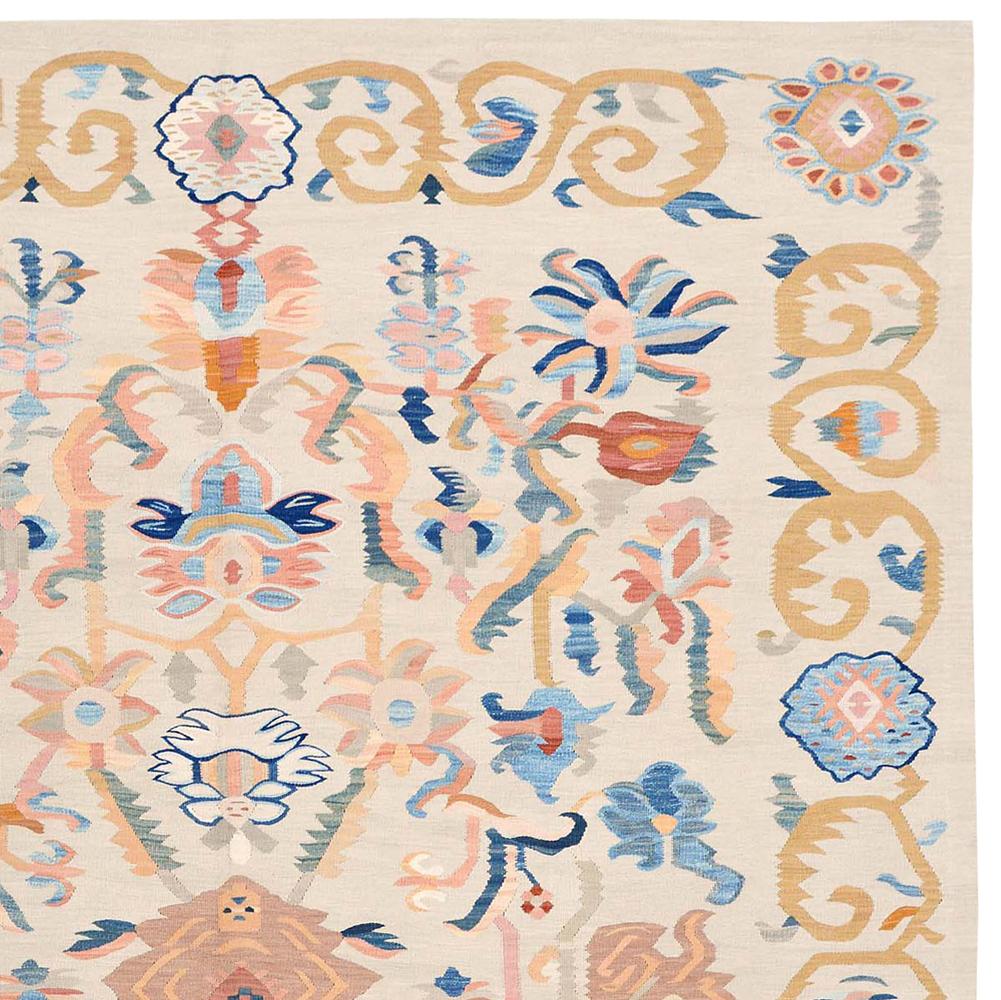This handwoven Aubusson flat-weave rug has thousands of subtle color shades, similar to antique Aubusson rugs. It is a beautiful Anatolian Aubusson rug with different kinds of flowers and blossoms in light rose, peach and light blue shades, made by