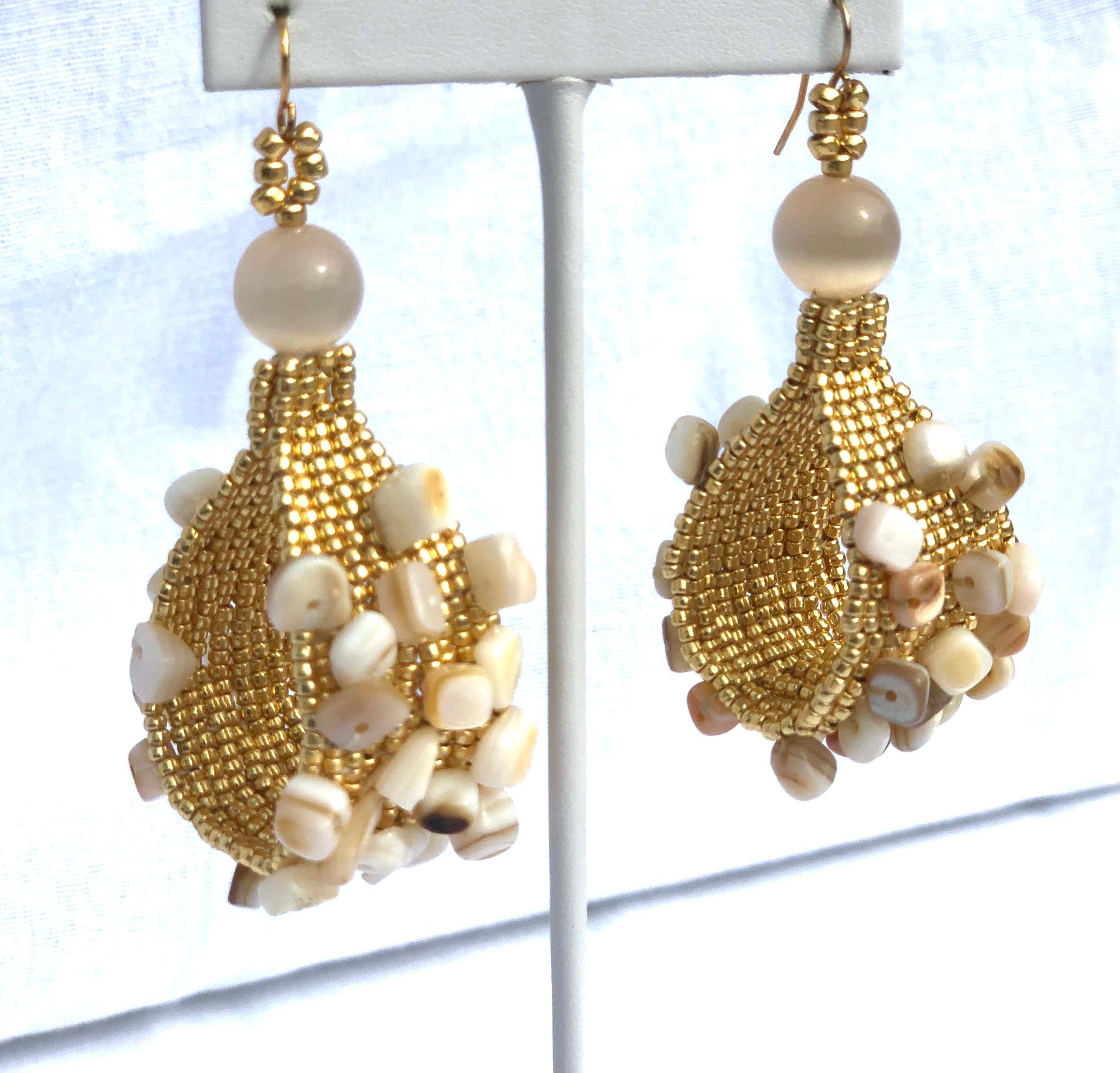 Handwoven gold plated seed bead Conchita hoop earrings with conch shell chip beads.