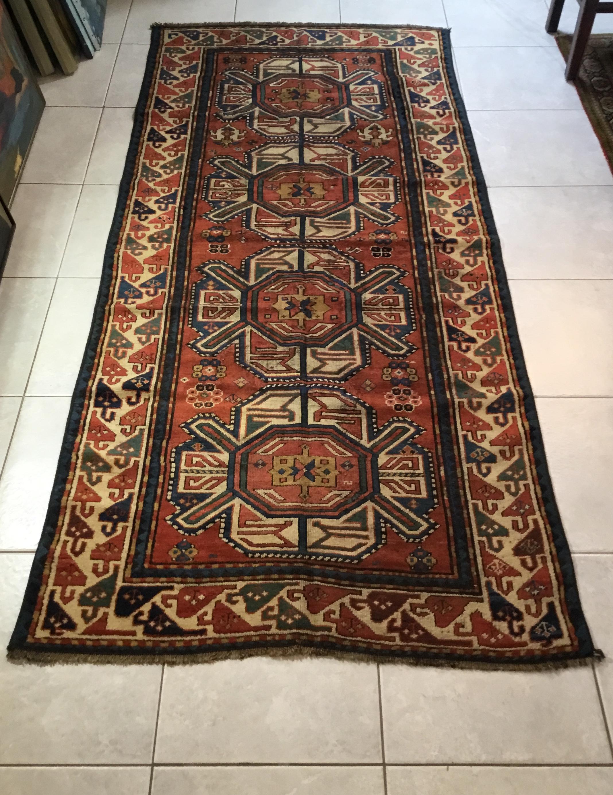 Beautiful antique handwoven Caucasian rug from the Karabagh region, all made with intriguing geometric motifs, four center medallions and exceptional three borders. Muted antique colors that you will get them only with age. This is one of my rugs i